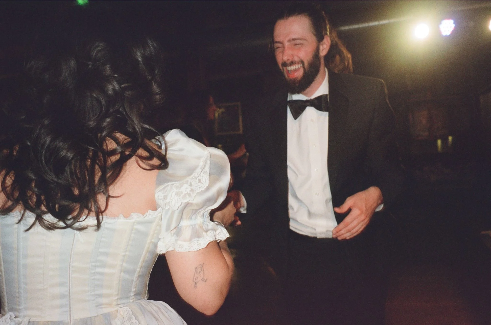 Bride and groom get married in Chicago at Salvage One, with creative, lively wedding focused on community, family, laughter. Documentary and candid photos on analog nostalgic film. Weddings by Grace is a Chicago lesbian queer luxury wedding photograp