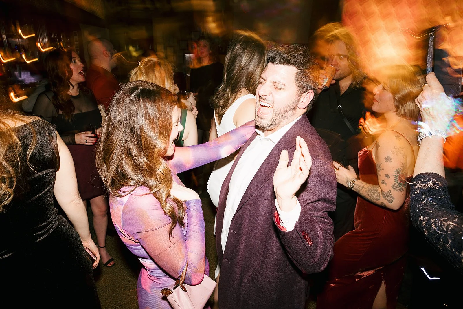 Fun flash photos of lesbian wedding at Dorothy bar. Documentary and candid photos on flash film. Weddings by Grace is a Chicago lesbian queer luxury wedding photographer specializing in portraits, candid, editorial, documentary, + artistic images wit