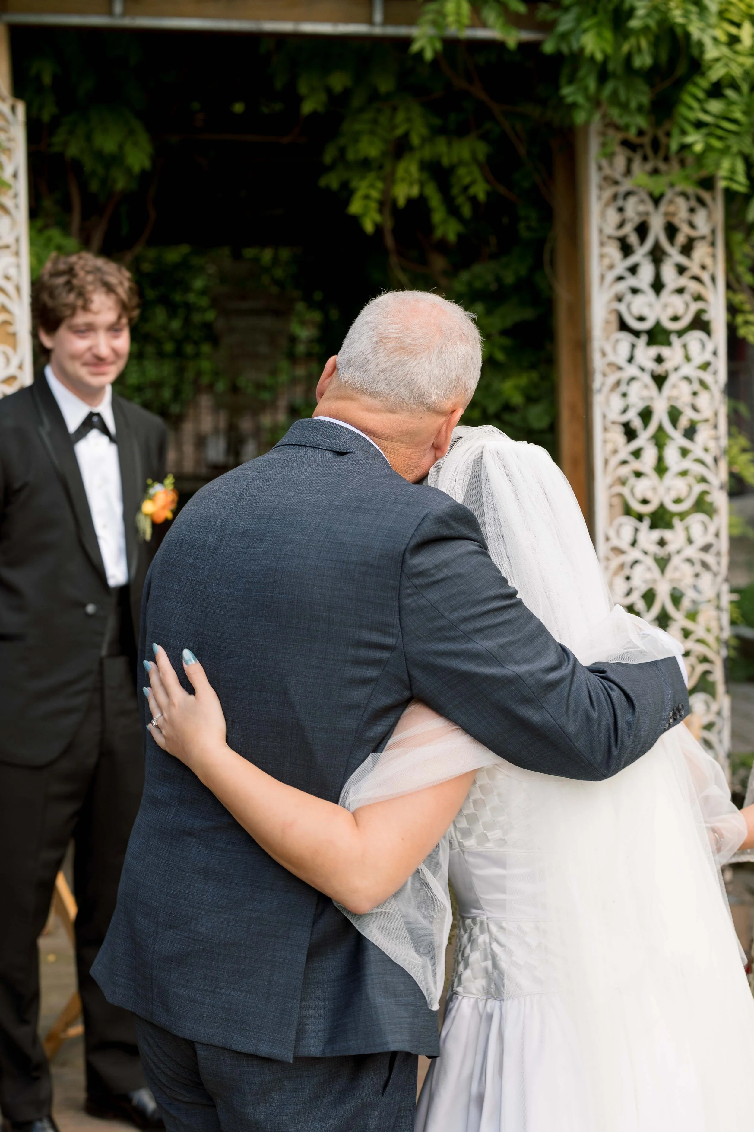 Bride and groom get married in Chicago at Salvage One, with creative, lively wedding focused on community, family, laughter. Documentary and candid photos on analog nostalgic film. Weddings by Grace is a Chicago lesbian queer luxury wedding photograp
