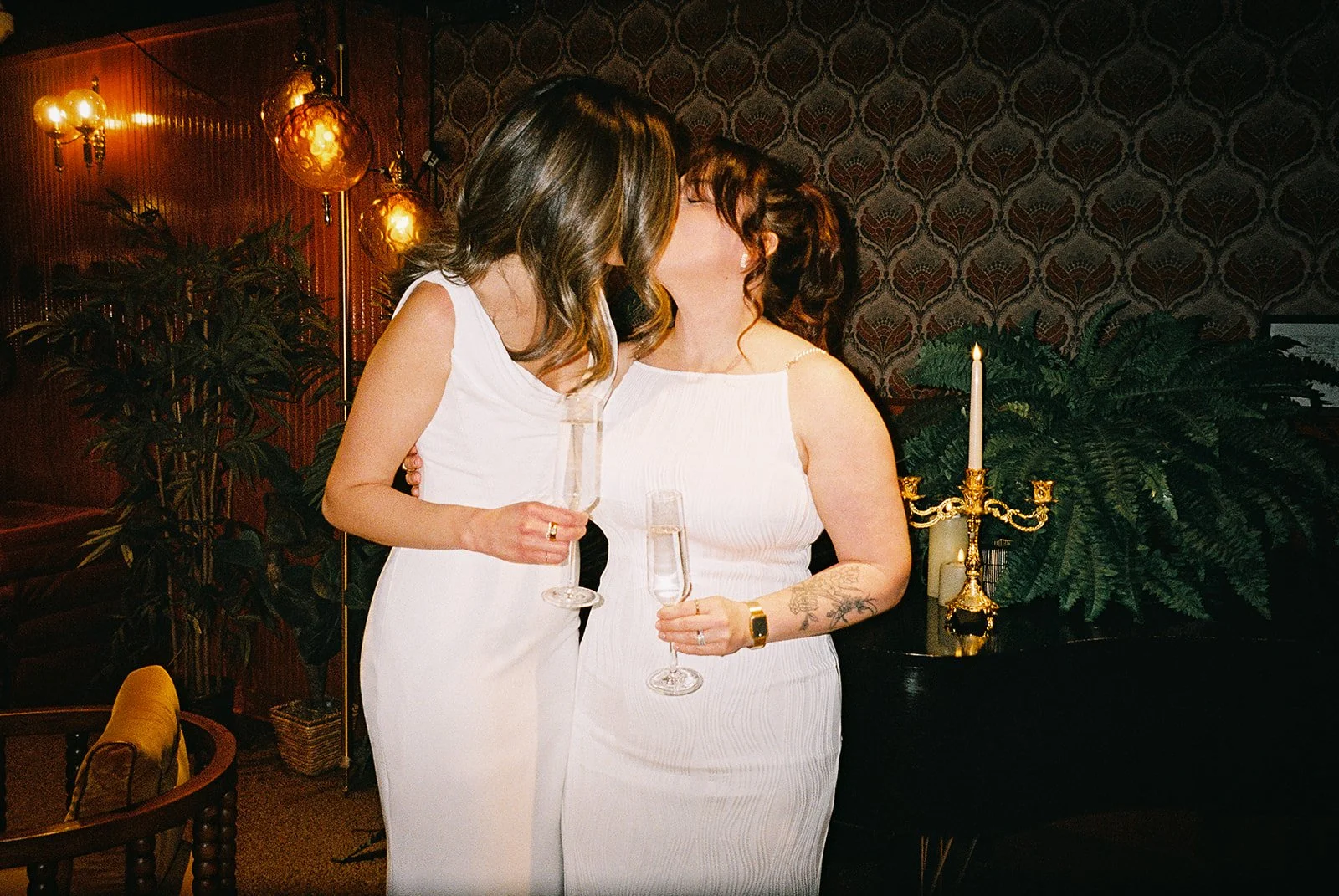 Fun flash photos of lesbian wedding at Dorothy bar. Documentary and candid photos on flash film. Weddings by Grace is a Chicago lesbian queer luxury wedding photographer specializing in portraits, candid, editorial, documentary, + artistic images wit