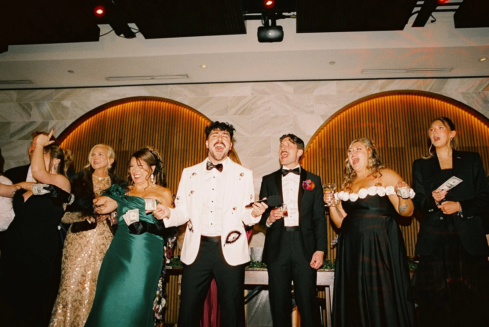 Two grooms get married downtown on Halloween night at chicago winery. Queer, gay, black tie, high-end party and drag show. Documentary and candid photos on flash film. Weddings by Grace is a Chicago lesbian queer luxury wedding photographer specializ