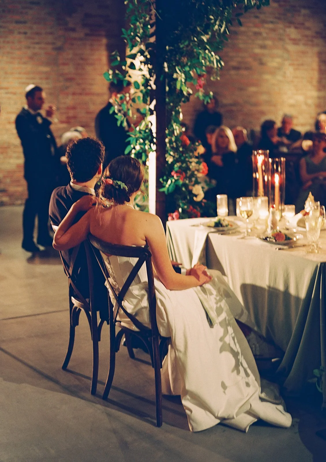 Bride and groom get married in Chicago at WildmanBT, with creative, lively wedding focused on community, family, laughter. Documentary and candid photos on flash film. Weddings by Grace is a Chicago lesbian queer luxury wedding photographer specializ