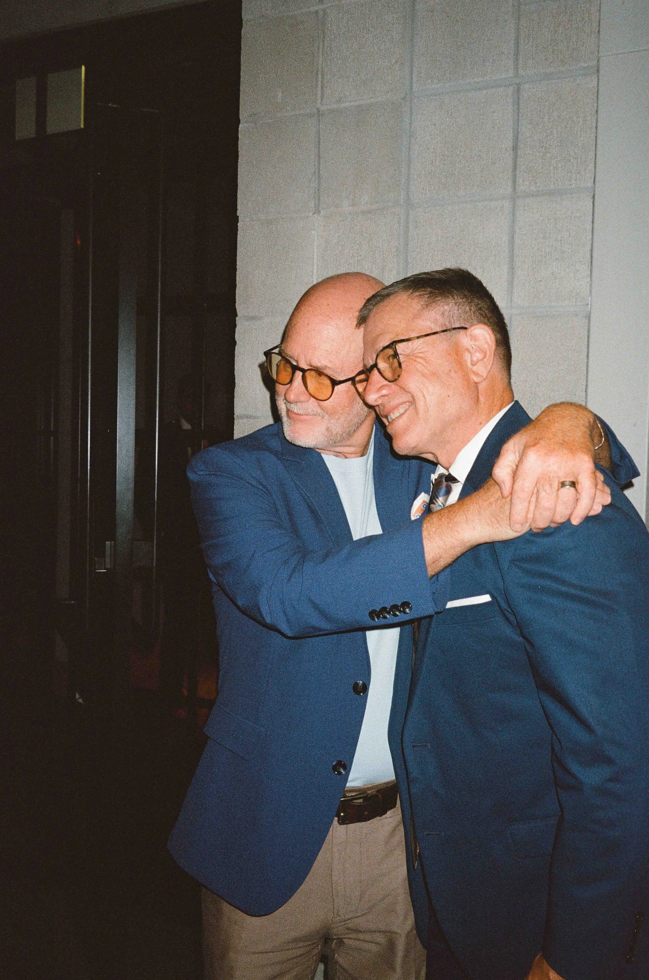 Groom and groom get married at maxwells trading with creative, lively wedding focused on community, queer family, laughter. Documentary and candid photos on analog nostalgic film. Weddings by Grace is a Chicago lesbian queer luxury wedding photograph