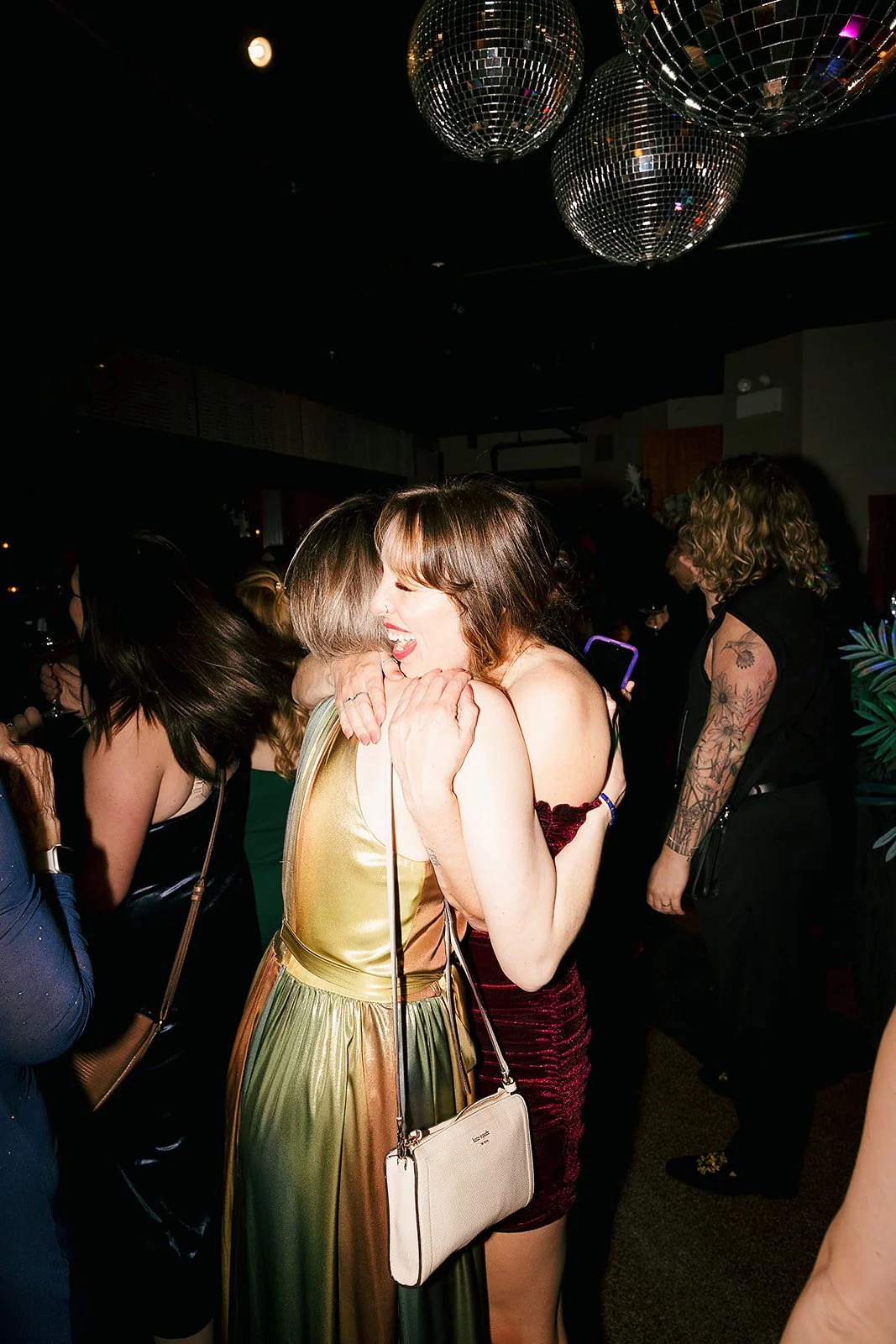 Fun flash photos of lesbian wedding at Dorothy bar. Documentary and candid photos on flash film. Weddings by Grace is a Chicago lesbian queer luxury wedding photographer specializing in portraits, candid, editorial, documentary, + artistic images wit
