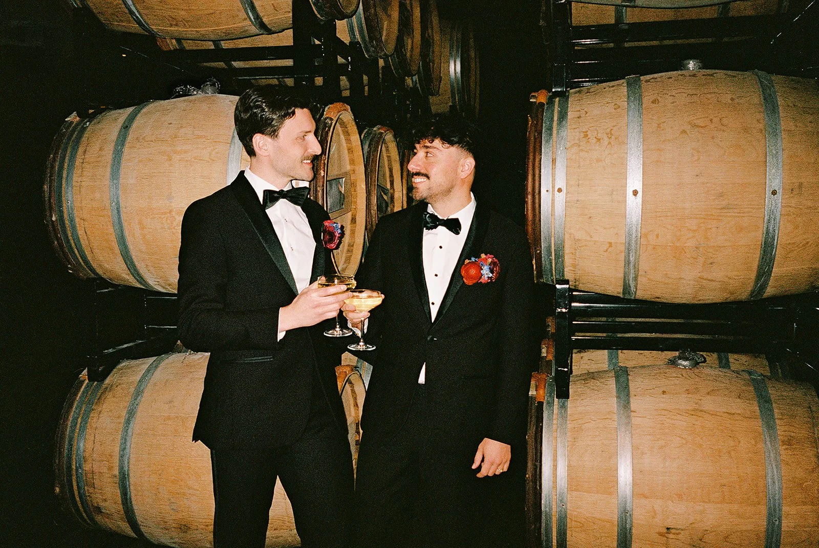 Two grooms get married downtown on Halloween night at chicago winery. Queer, gay, black tie, high-end party and drag show. Documentary and candid photos on flash film. Weddings by Grace is a Chicago lesbian queer luxury wedding photographer specializ