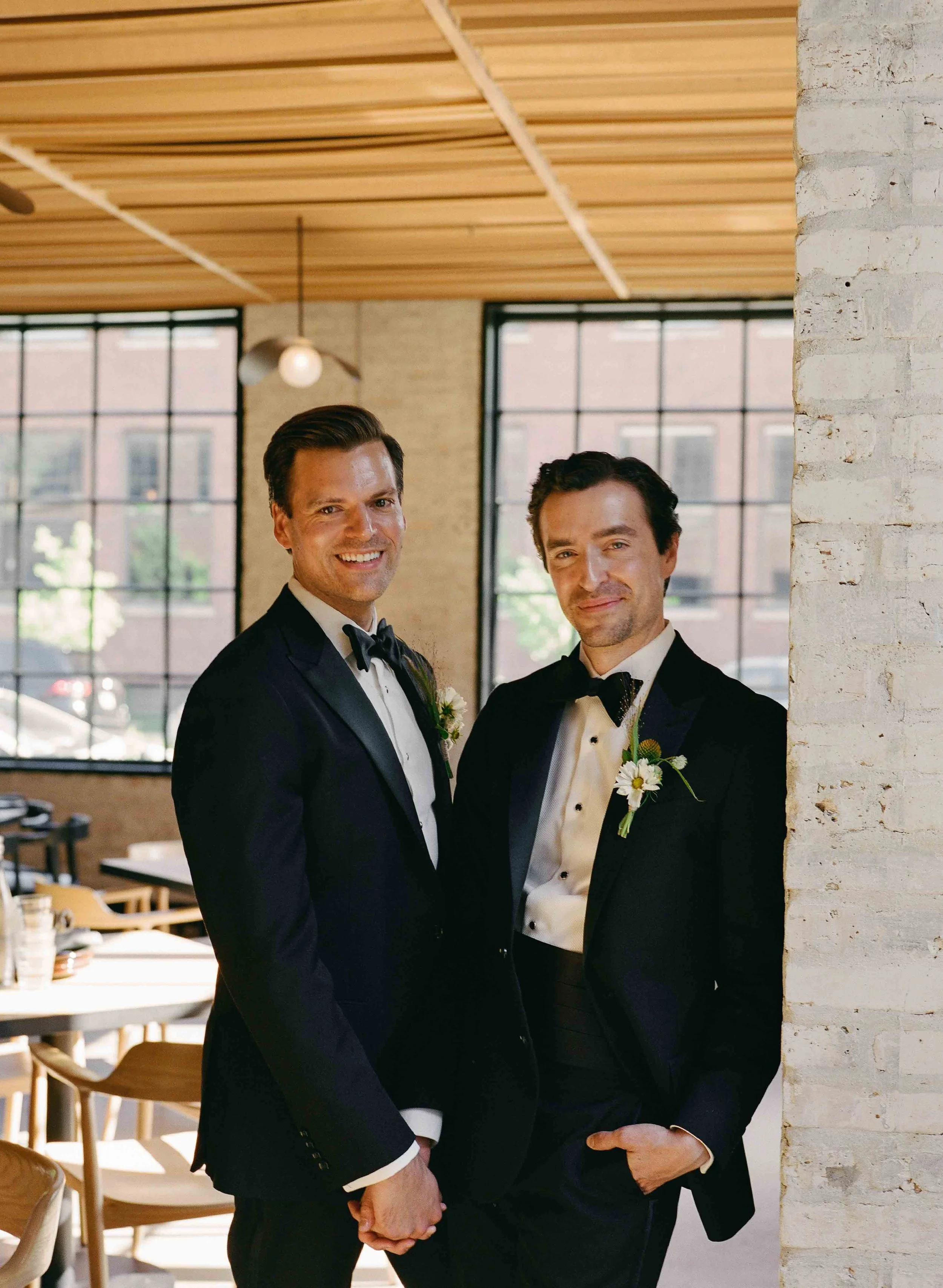 Groom and groom get married at maxwells trading with creative, lively wedding focused on community, queer family, laughter. Documentary and candid photos on analog nostalgic film. Weddings by Grace is a Chicago lesbian queer luxury wedding photograph