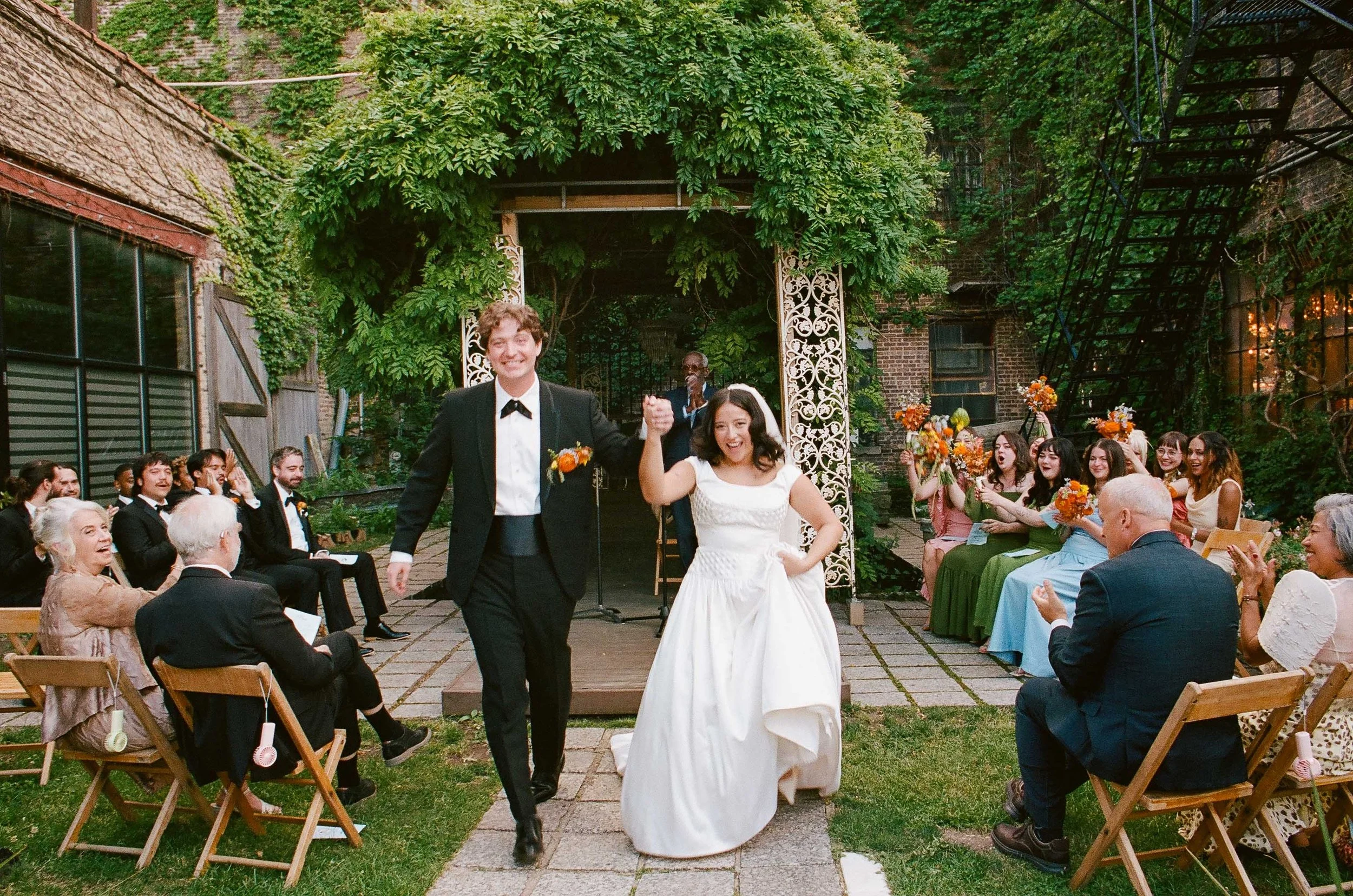 Bride and groom get married in Chicago at Salvage One, with creative, lively wedding focused on community, family, laughter. Documentary and candid photos on analog nostalgic film. Weddings by Grace is a Chicago lesbian queer luxury wedding photograp