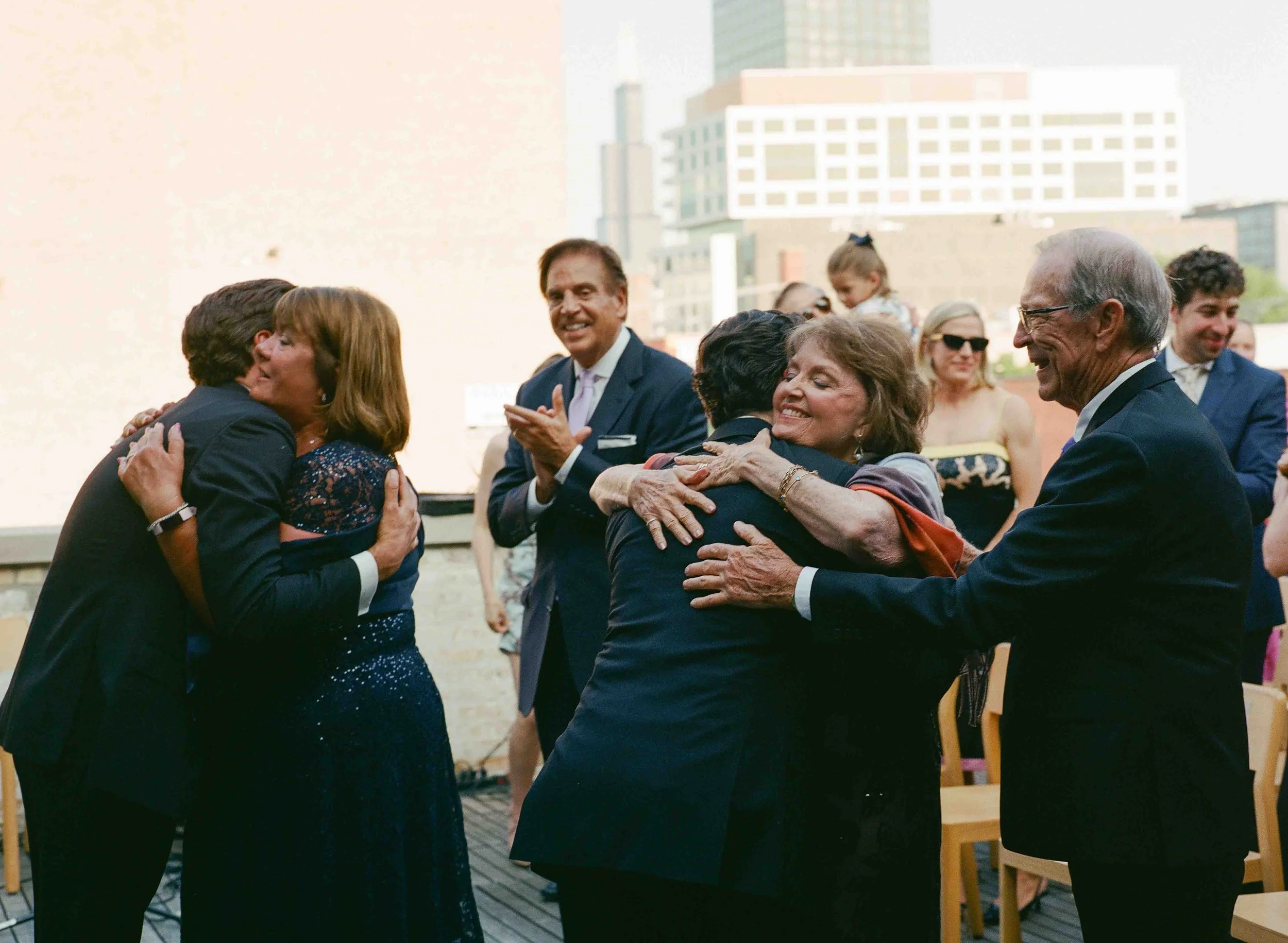 Groom and groom get married at maxwells trading with creative, lively wedding focused on community, queer family, laughter. Documentary and candid photos on analog nostalgic film. Weddings by Grace is a Chicago lesbian queer luxury wedding photograph
