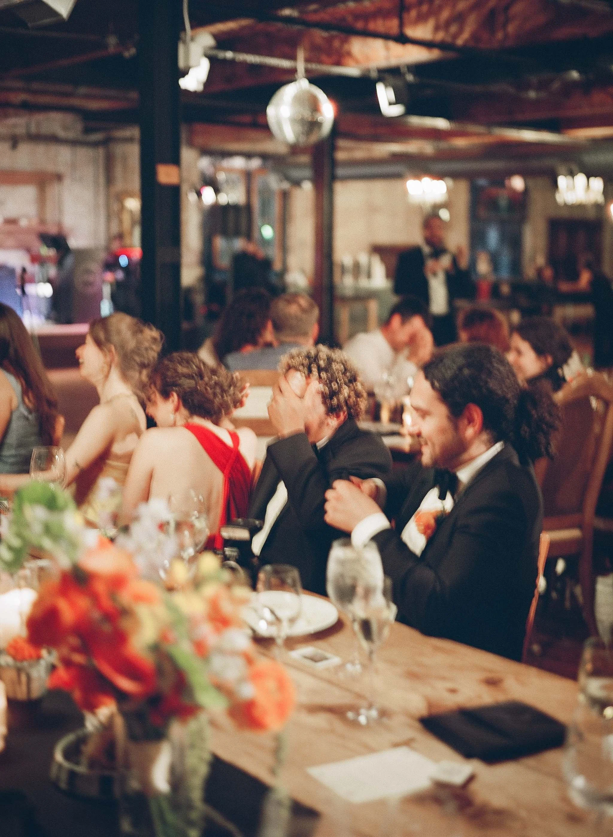 Bride and groom get married in Chicago at Salvage One, with creative, lively wedding focused on community, family, laughter. Documentary and candid photos on analog nostalgic film. Weddings by Grace is a Chicago lesbian queer luxury wedding photograp