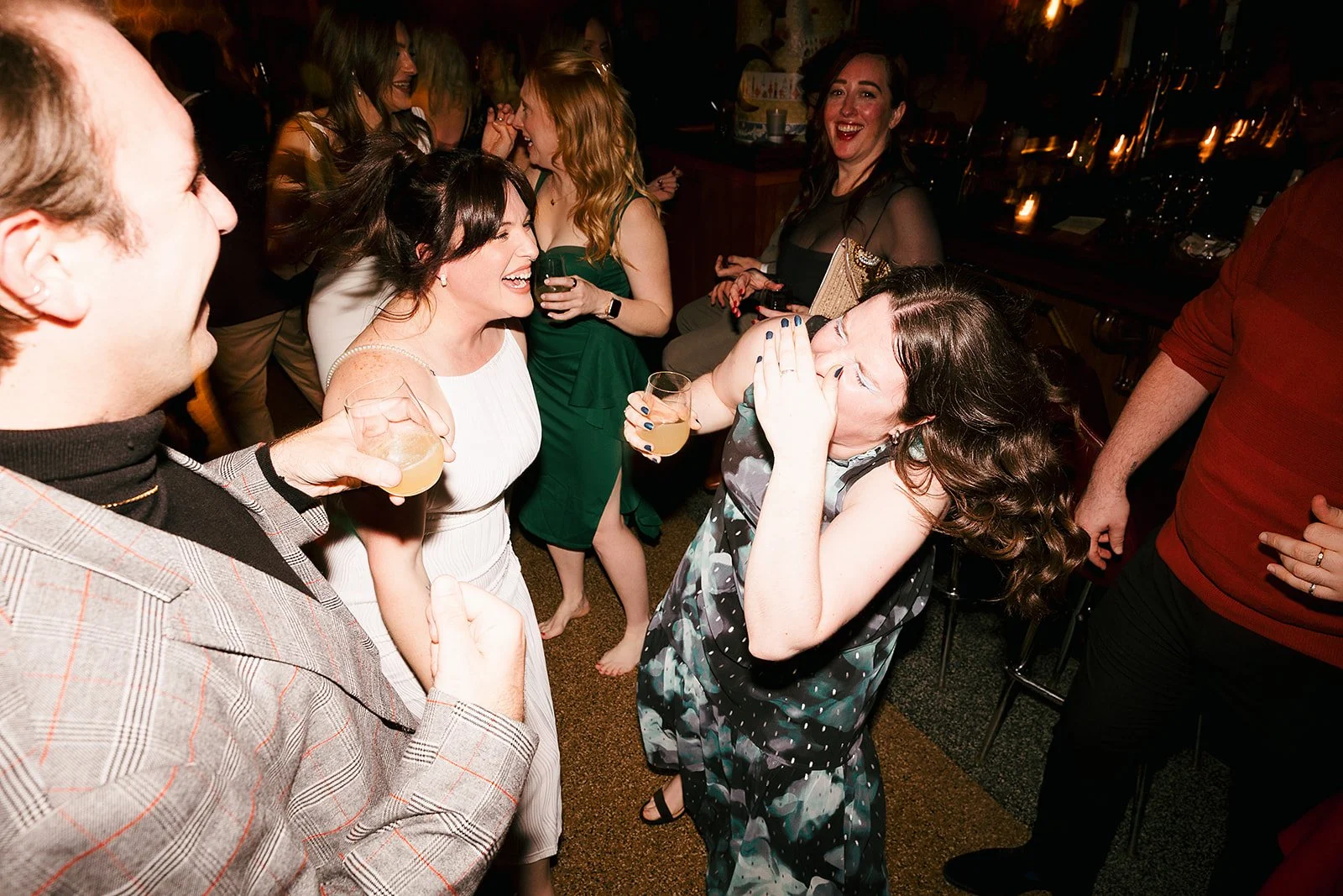 Fun flash photos of lesbian wedding at Dorothy bar. Documentary and candid photos on flash film. Weddings by Grace is a Chicago lesbian queer luxury wedding photographer specializing in portraits, candid, editorial, documentary, + artistic images wit