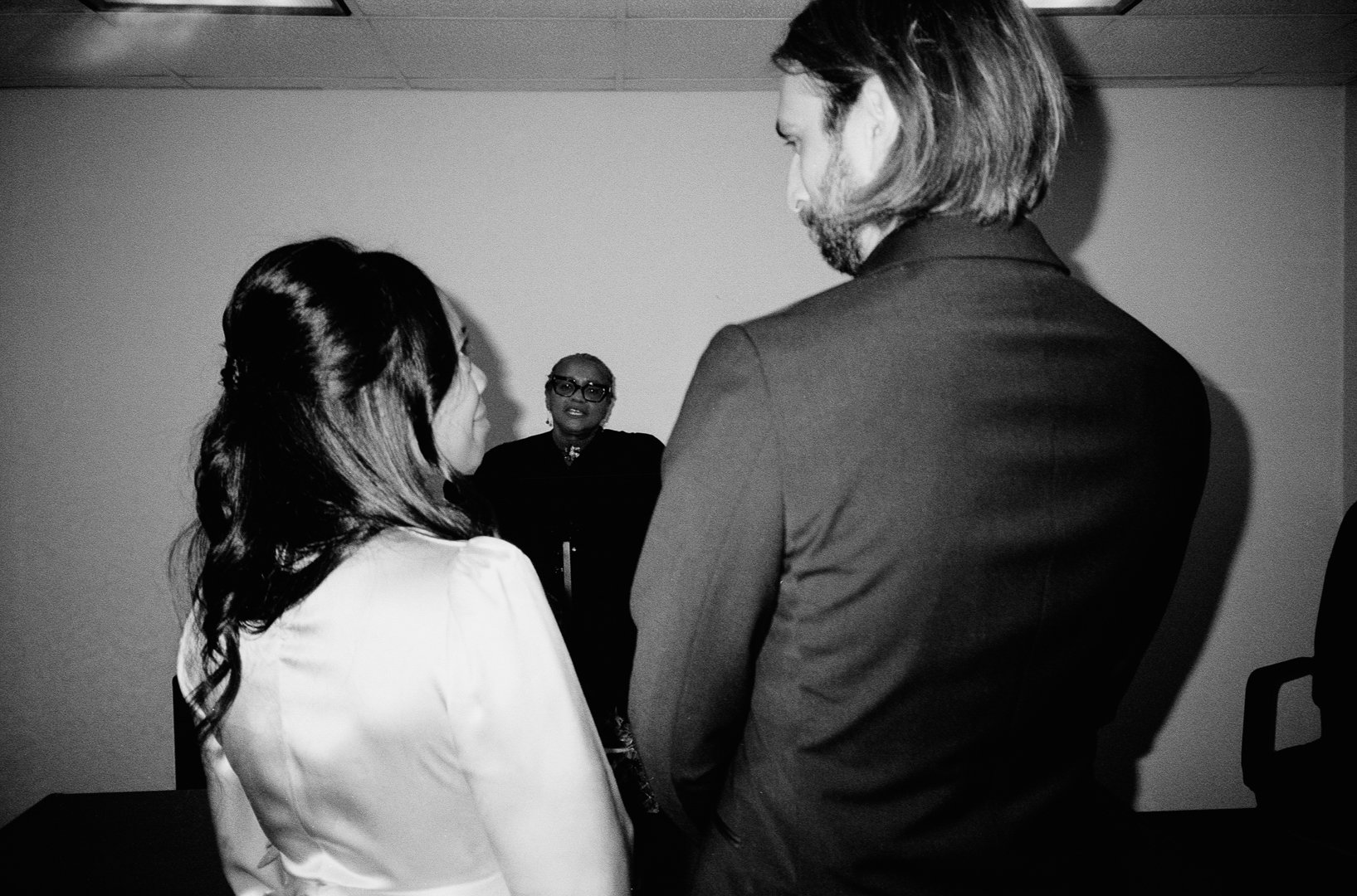 Bride and groom stand at City Hall Elopement in downtown chicago to get married on film. Grace Coudal is a Chicago lesbian photographer specializing in portraits, candid, editorial, documentary, events, + weddings. Analog film wedding photography, qu