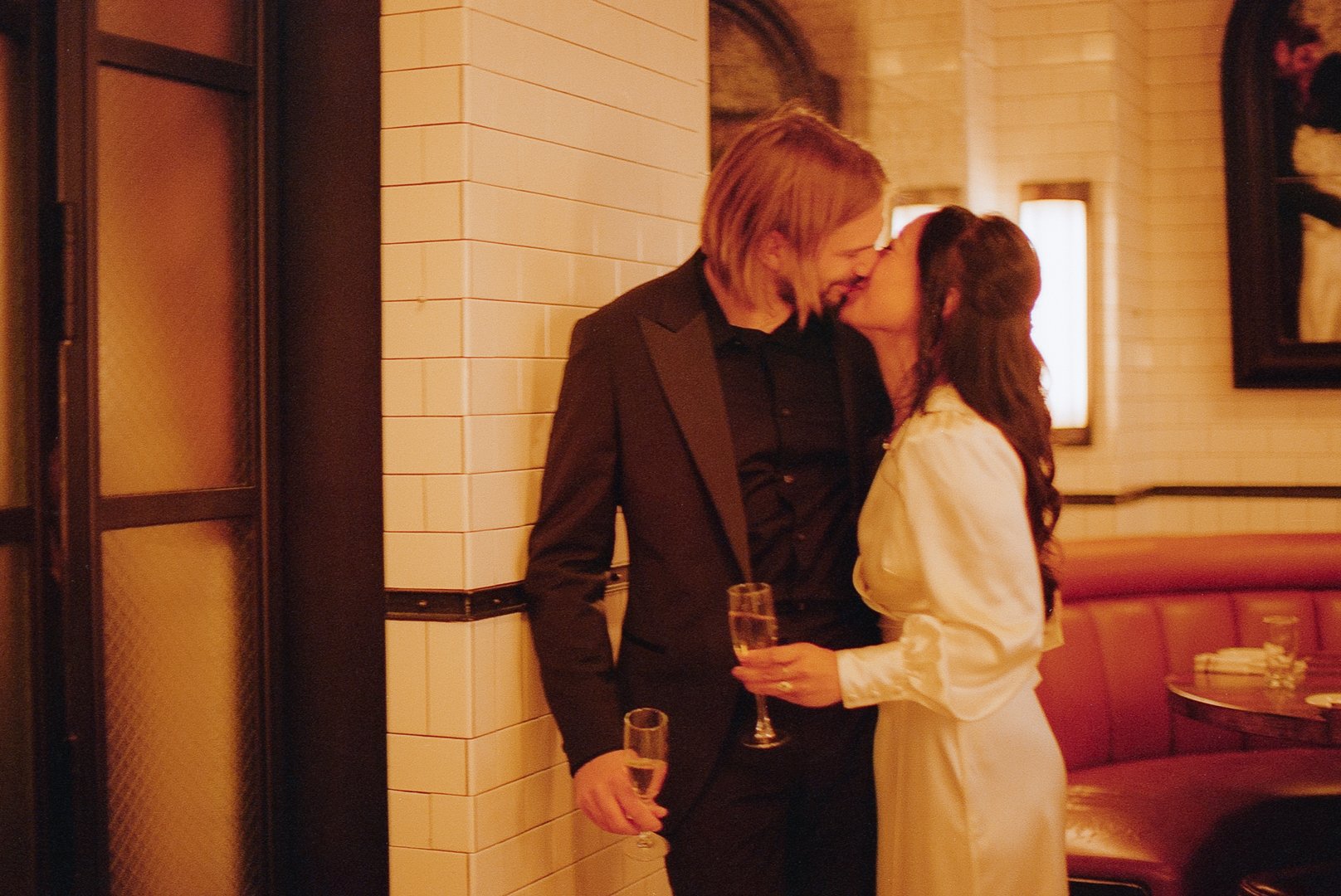 bride and groom kiss at elopement party at the smith after eloping at City Hall downtown chicago. Grace Coudal is a Chicago lesbian photographer specializing in portraits, candid, editorial, documentary, events, + weddings. Analog film wedding photo