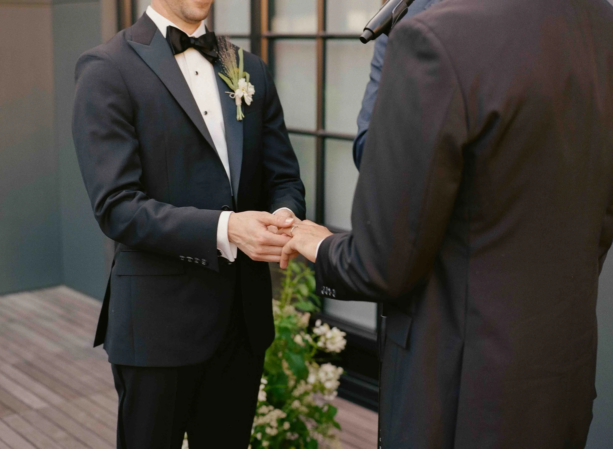 Groom and groom get married at maxwells trading with creative, lively wedding focused on community, queer family, laughter. Documentary and candid photos on analog nostalgic film. Weddings by Grace is a Chicago lesbian queer luxury wedding photograph