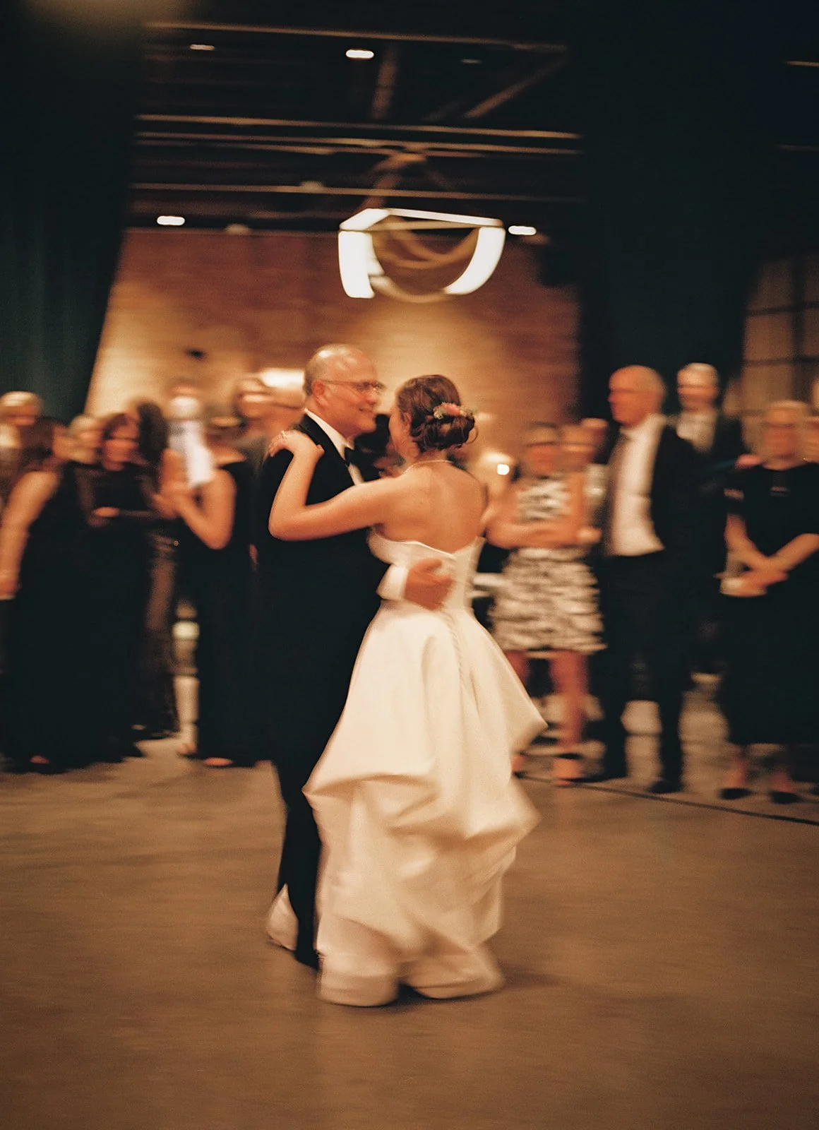 Bride and groom get married in Chicago at WildmanBT, with creative, lively wedding focused on community, family, laughter. Documentary and candid photos on flash film. Weddings by Grace is a Chicago lesbian queer luxury wedding photographer specializ