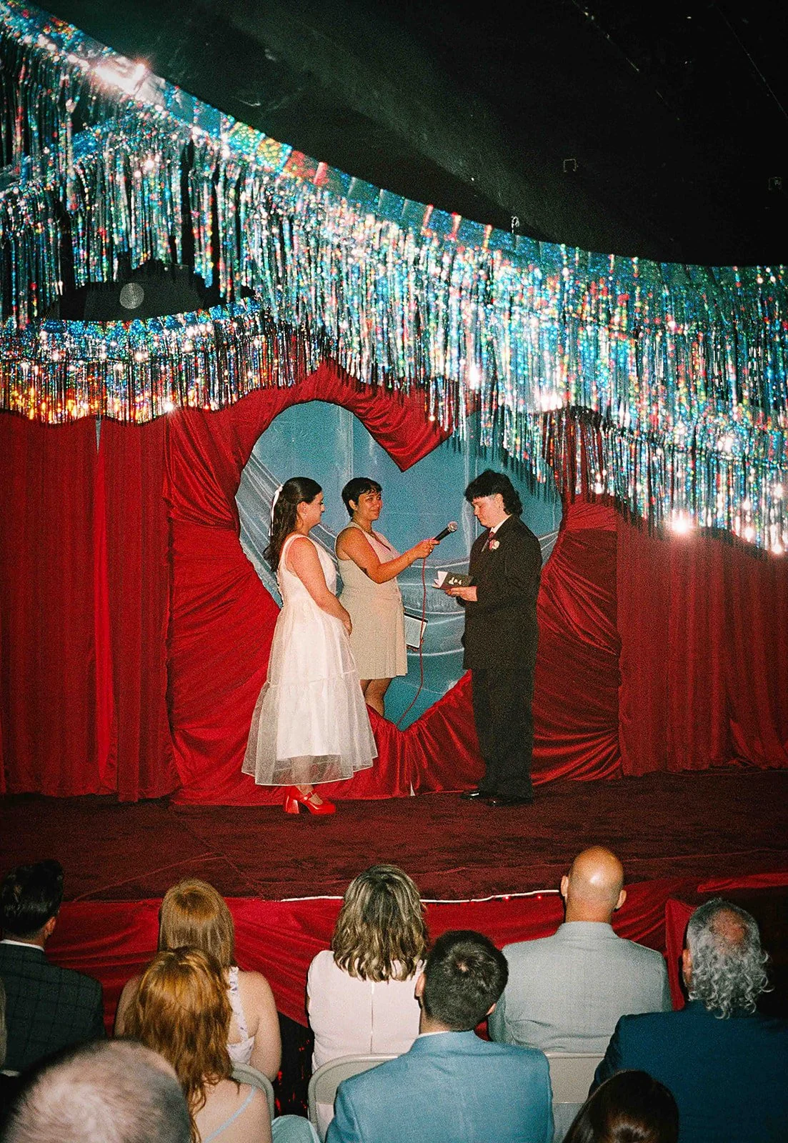 Queer couple gets married in Chicago at the empty bottle with creative, lively wedding focused on community, family, laughter. Documentary and candid photos on analog nostalgic film. Weddings by Grace is a Chicago lesbian queer luxury wedding photogr