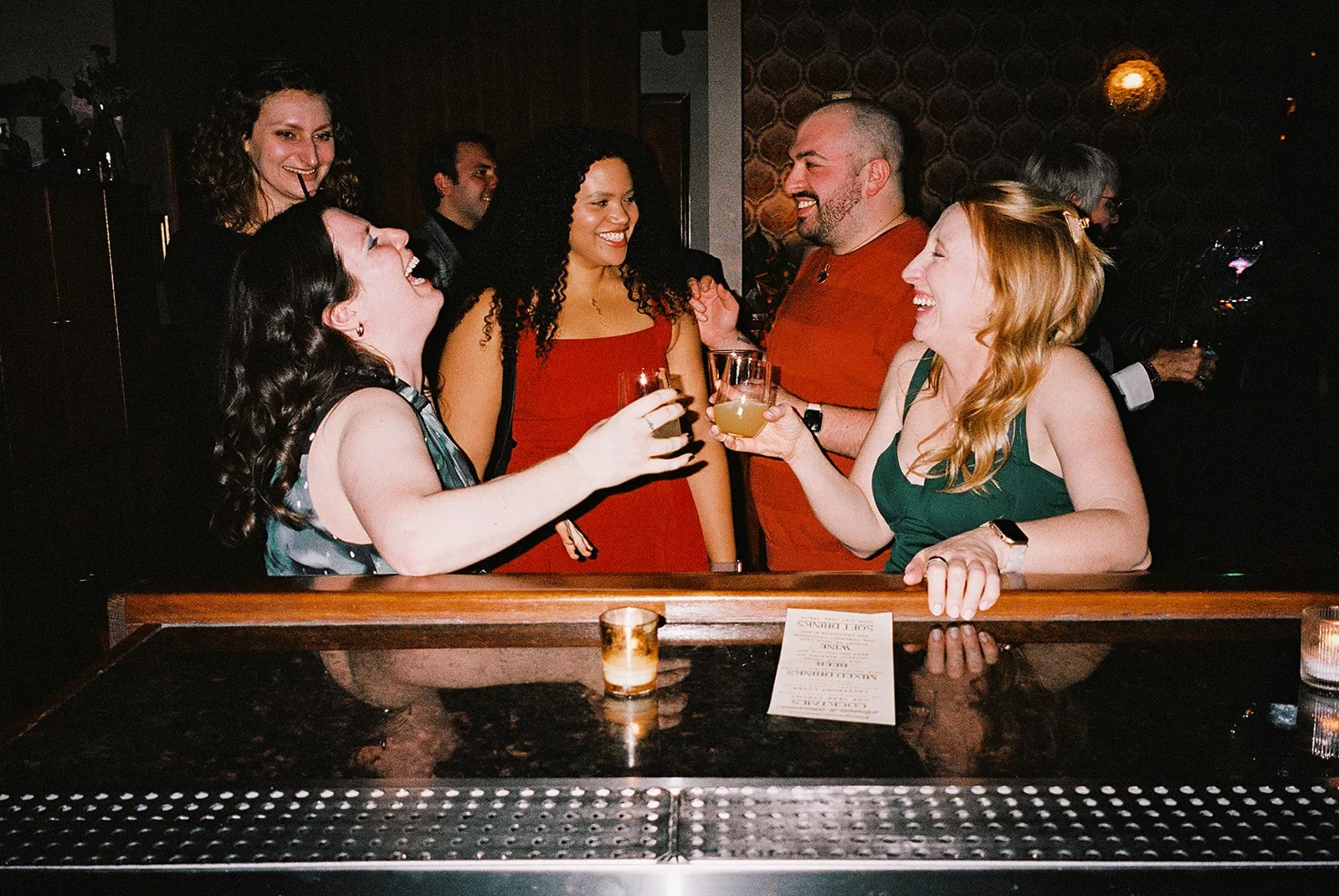 Fun flash photos of lesbian wedding at Dorothy bar. Documentary and candid photos on flash film. Weddings by Grace is a Chicago lesbian queer luxury wedding photographer specializing in portraits, candid, editorial, documentary, + artistic images wit