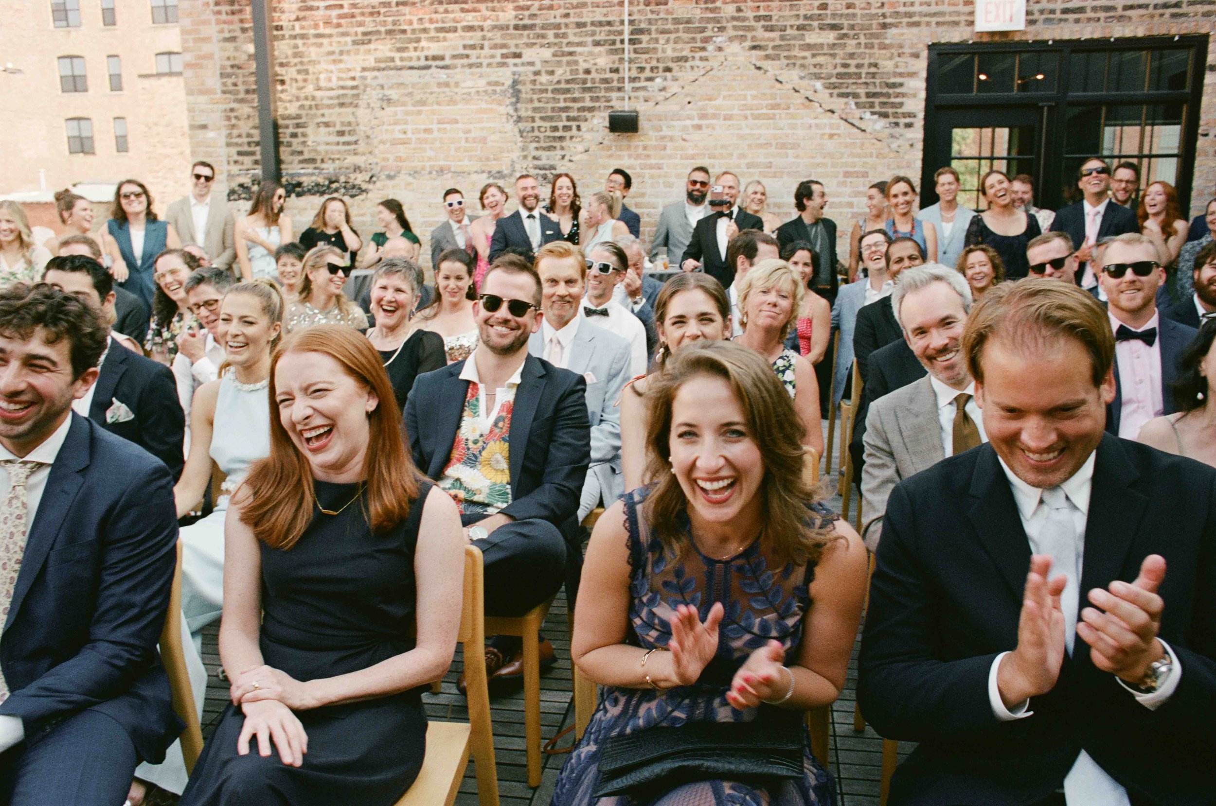Groom and groom get married at maxwells trading with creative, lively wedding focused on community, queer family, laughter. Documentary and candid photos on analog nostalgic film. Weddings by Grace is a Chicago lesbian queer luxury wedding photograph
