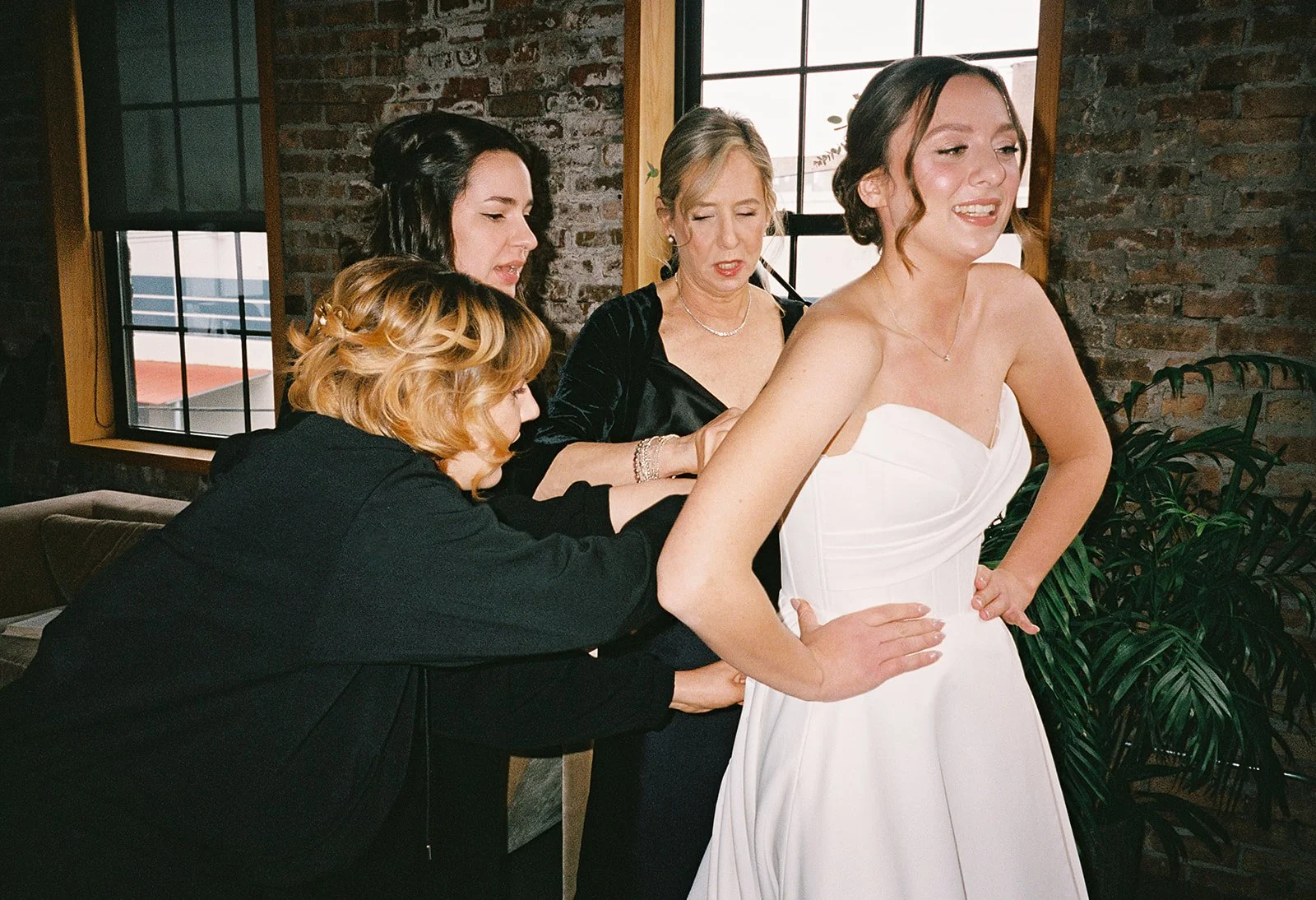 Bride and groom get married in Chicago at WildmanBT, with creative, lively wedding focused on community, family, laughter. Documentary and candid photos on flash film. Weddings by Grace is a Chicago lesbian queer luxury wedding photographer specializ