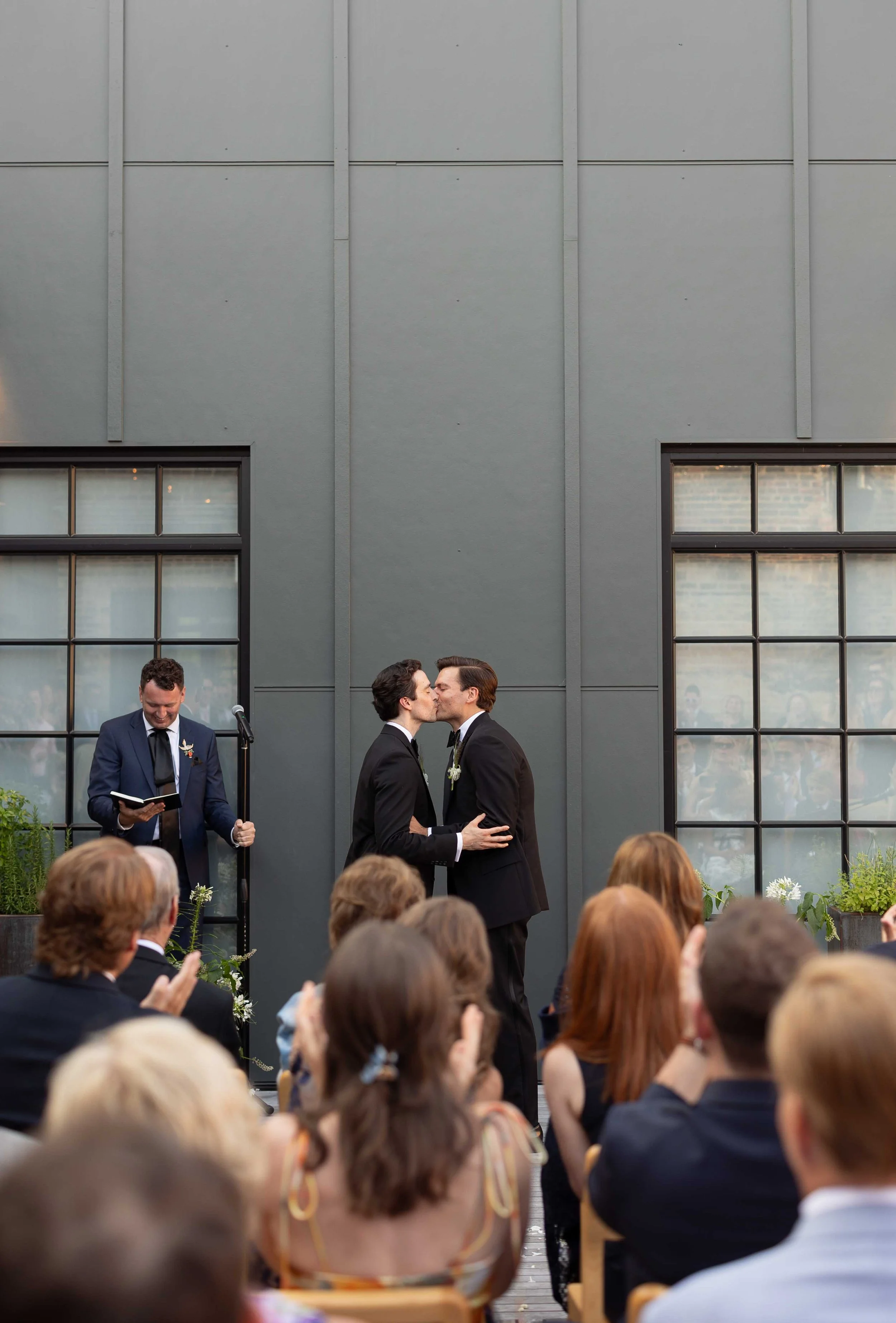 Groom and groom get married at maxwells trading with creative, lively wedding focused on community, queer family, laughter. Documentary and candid photos on analog nostalgic film. Weddings by Grace is a Chicago lesbian queer luxury wedding photograph