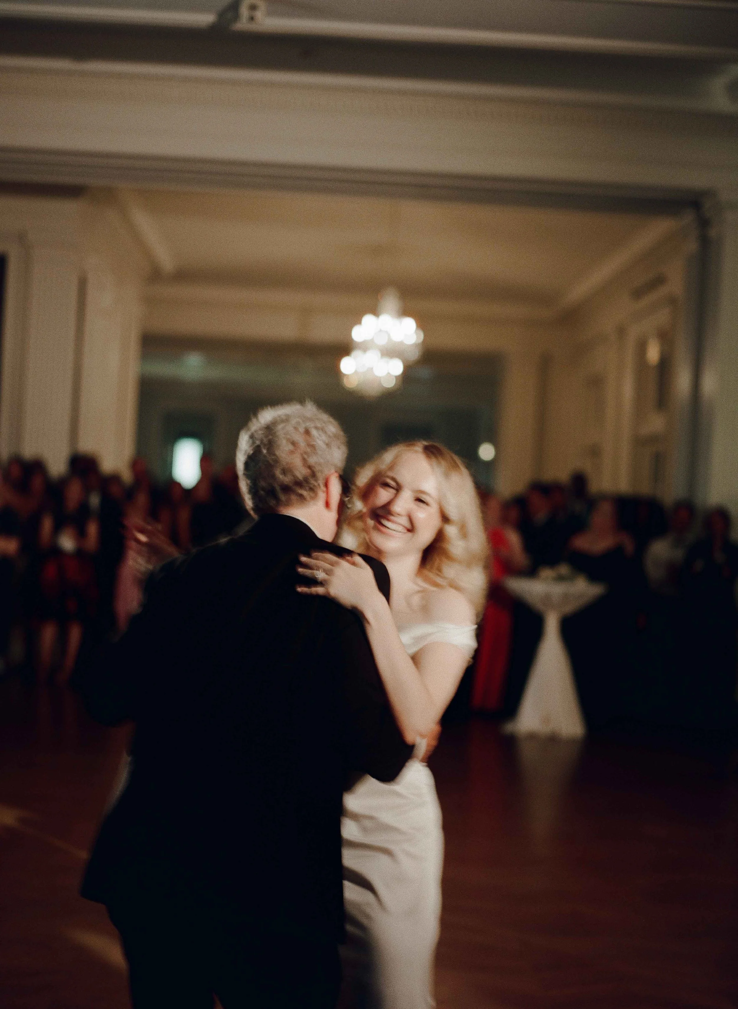 Bride and groom get married at the Chicago History Museum, with creative, lively wedding focused on community, family, laughter. Documentary and candid photos on analog nostalgic film. Weddings by Grace is a Chicago lesbian queer luxury wedding photo