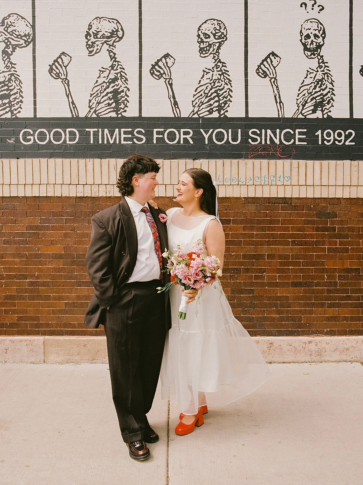 Queer couple gets married in Chicago at the empty bottle with creative, lively wedding focused on community, family, laughter. Documentary and candid photos on analog nostalgic film. Weddings by Grace is a Chicago lesbian queer luxury wedding photogr