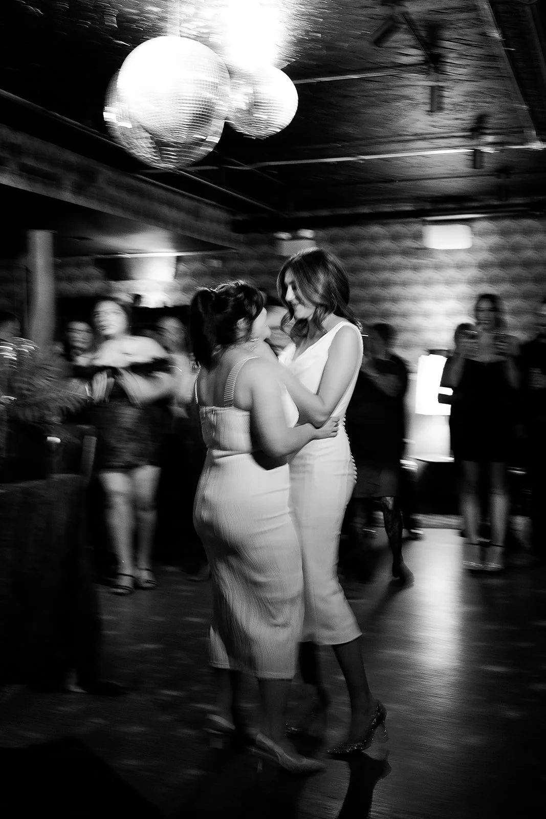 Fun flash photos of lesbian wedding at Dorothy bar. Documentary and candid photos on flash film. Weddings by Grace is a Chicago lesbian queer luxury wedding photographer specializing in portraits, candid, editorial, documentary, + artistic images wit