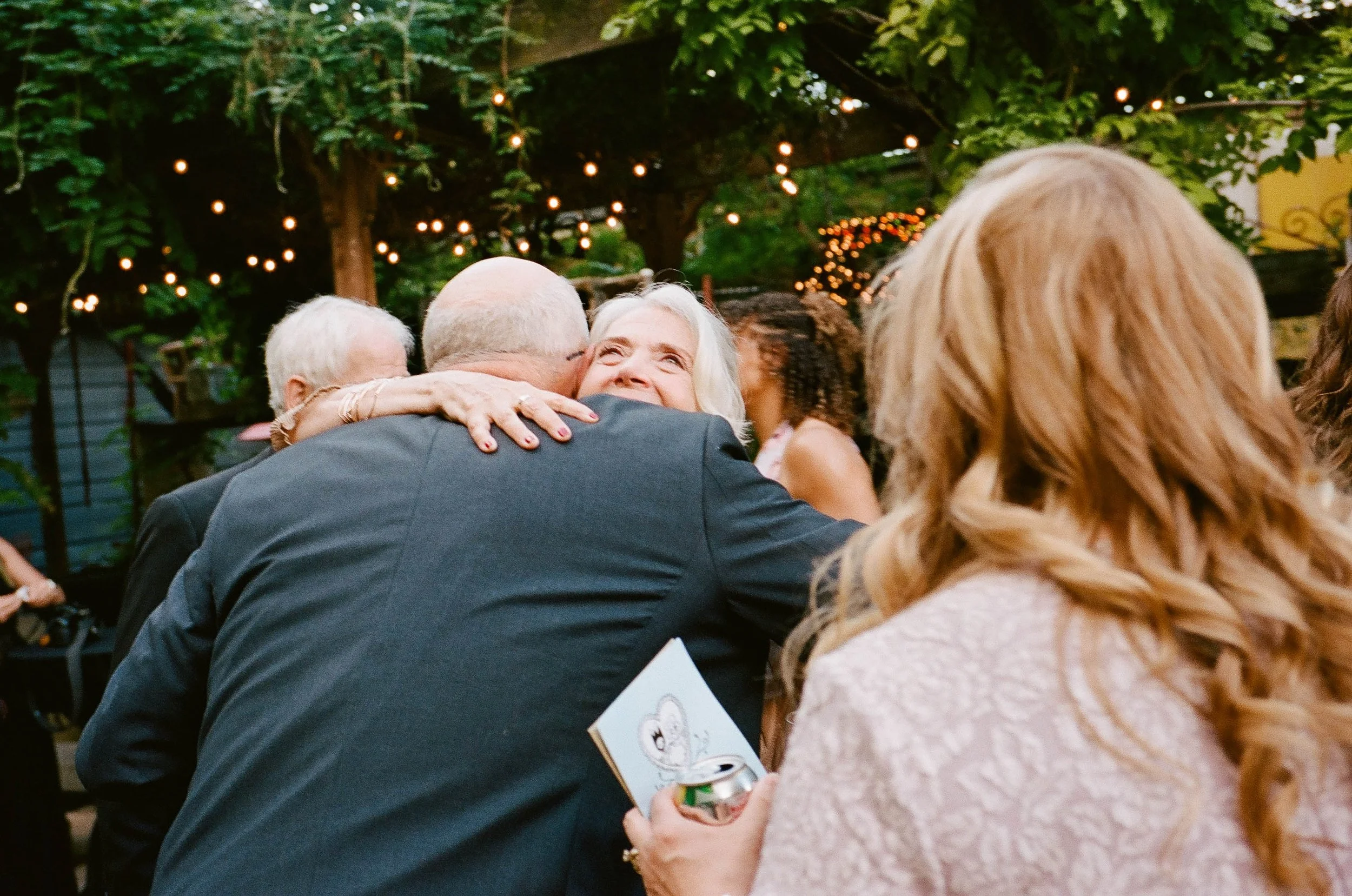 Bride and groom get married in Chicago at Salvage One, with creative, lively wedding focused on community, family, laughter. Documentary and candid photos on analog nostalgic film. Weddings by Grace is a Chicago lesbian queer luxury wedding photograp