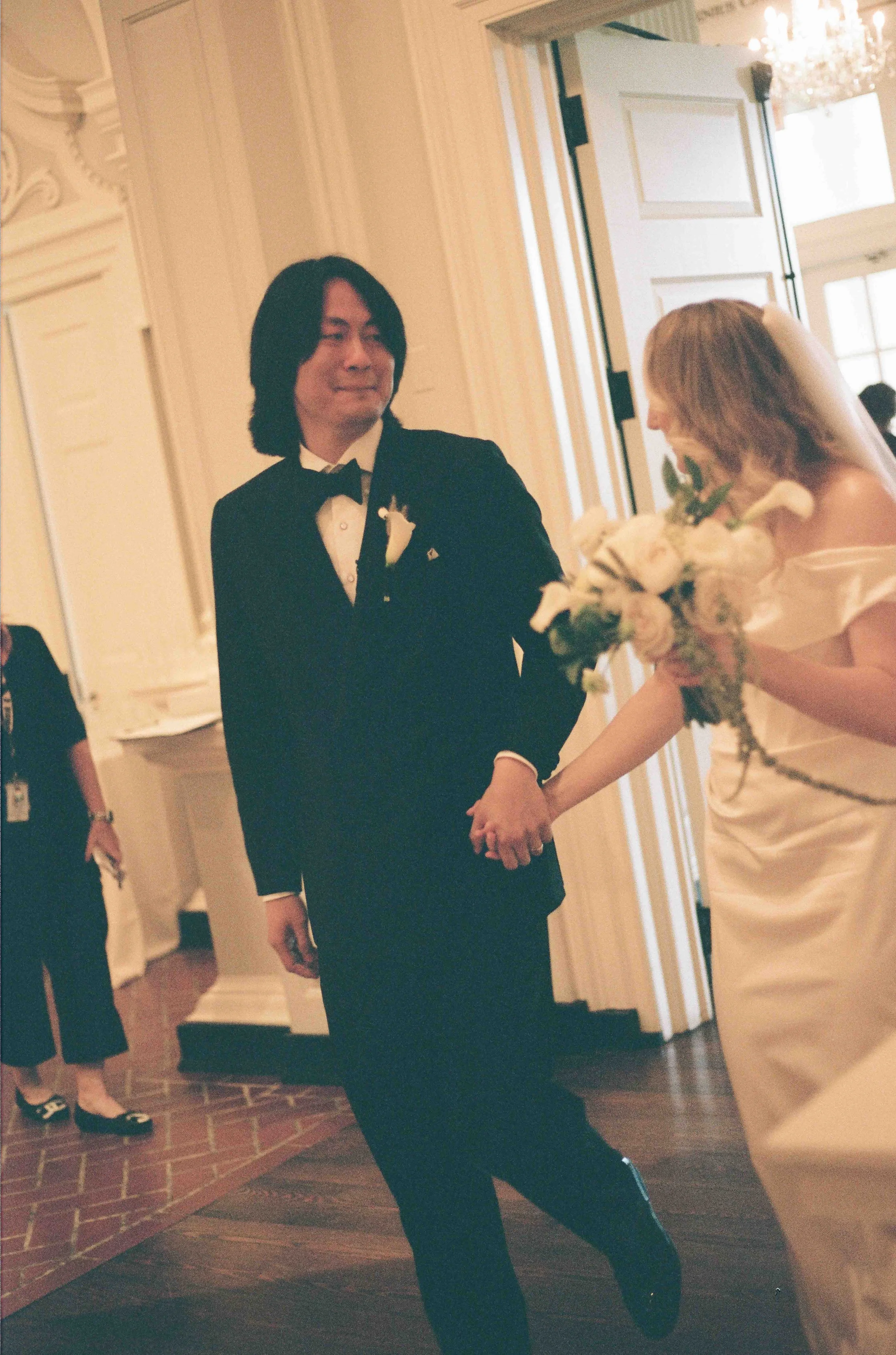 Bride and groom get married at the Chicago History Museum, with creative, lively wedding focused on community, family, laughter. Documentary and candid photos on analog nostalgic film. Weddings by Grace is a Chicago lesbian queer luxury wedding photo