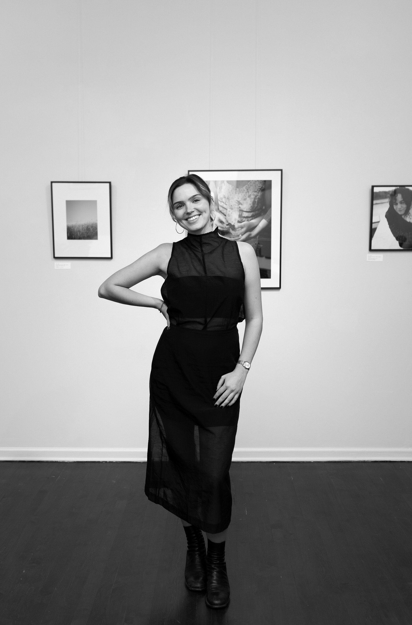 black and white candid photo of weddings by grace at her west town solo show fine art exhibition. Luxury, high-end wedding photographer shot on film. Weddings by grace is a Chicago lesbian queer photographer specializing in portraits, candid, editori
