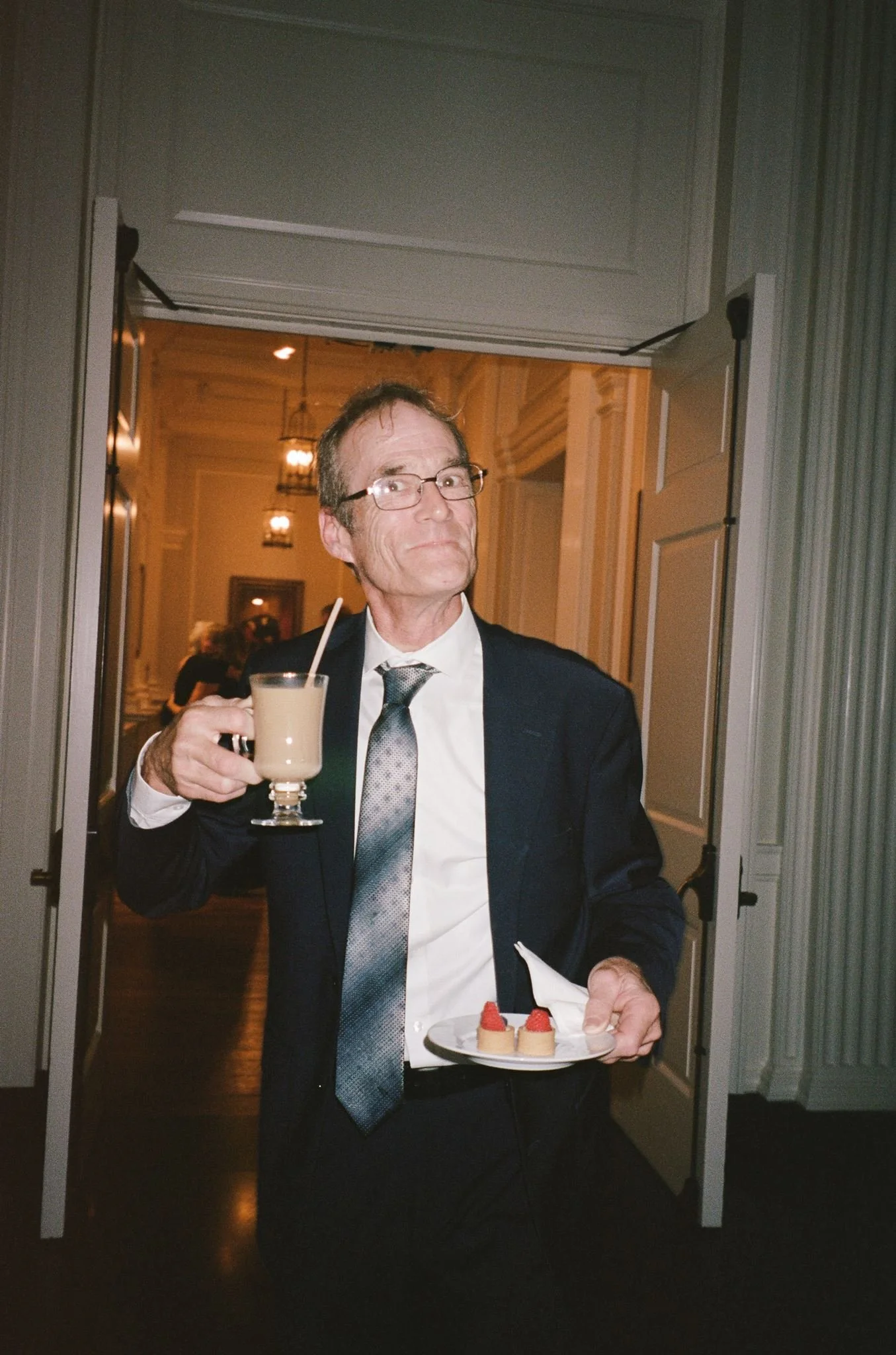Bride and groom get married at the Chicago History Museum, with creative, lively wedding focused on community, family, laughter. Documentary and candid photos on analog nostalgic film. Weddings by Grace is a Chicago lesbian queer luxury wedding photo