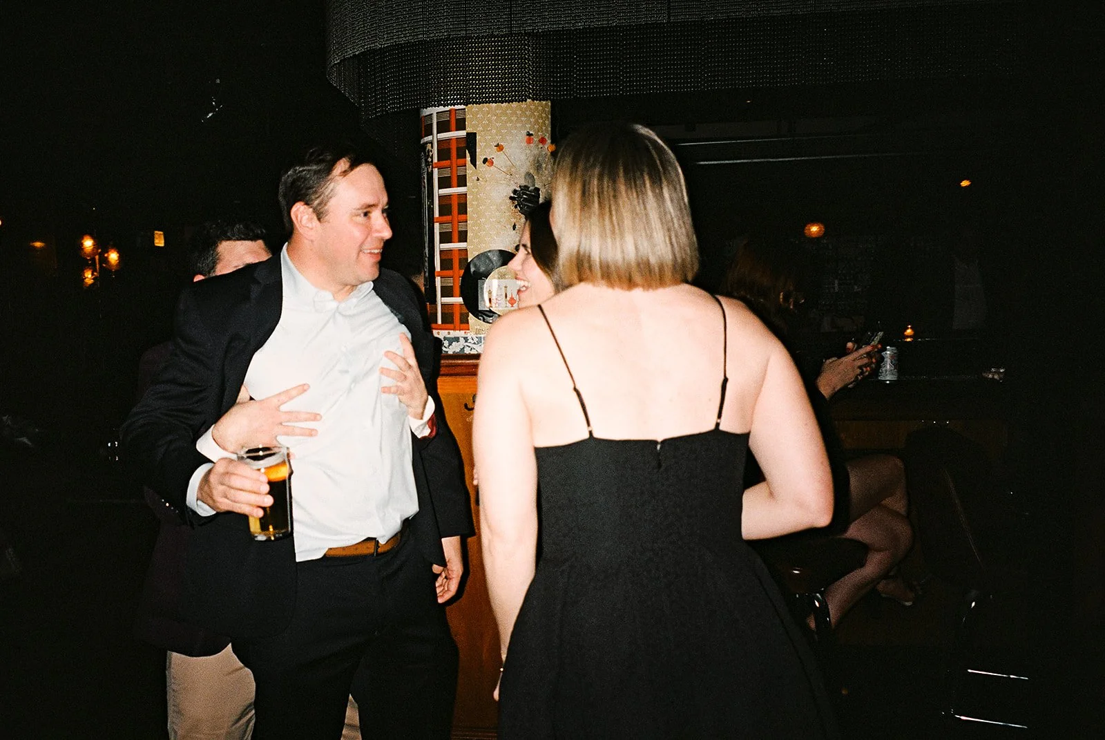 Fun flash photos of lesbian wedding at Dorothy bar. Documentary and candid photos on flash film. Weddings by Grace is a Chicago lesbian queer luxury wedding photographer specializing in portraits, candid, editorial, documentary, + artistic images wit