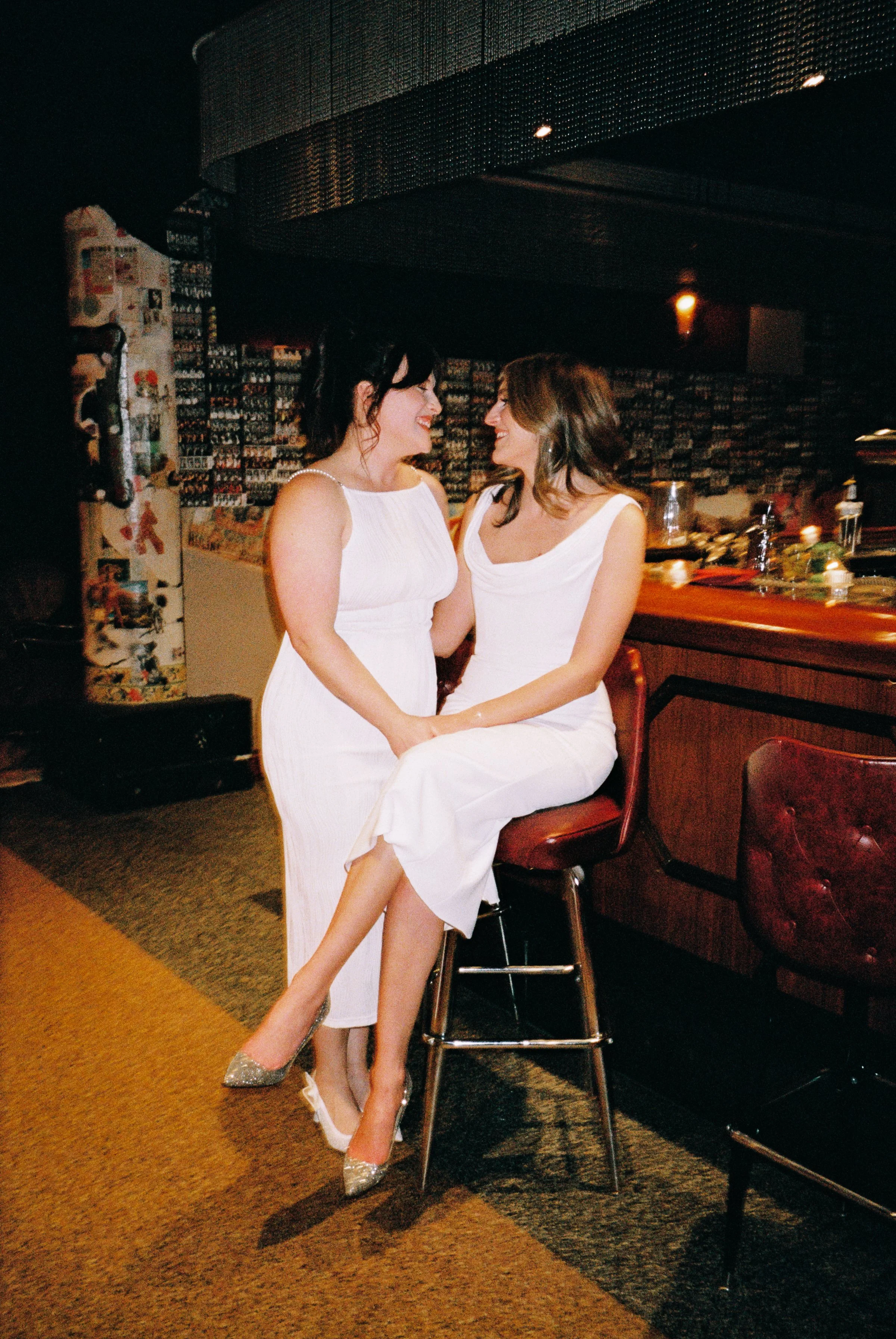Fun flash photos of lesbian wedding at Dorothy bar. Documentary and candid photos on flash film. Weddings by Grace is a Chicago lesbian queer luxury wedding photographer specializing in portraits, candid, editorial, documentary, + artistic images wit