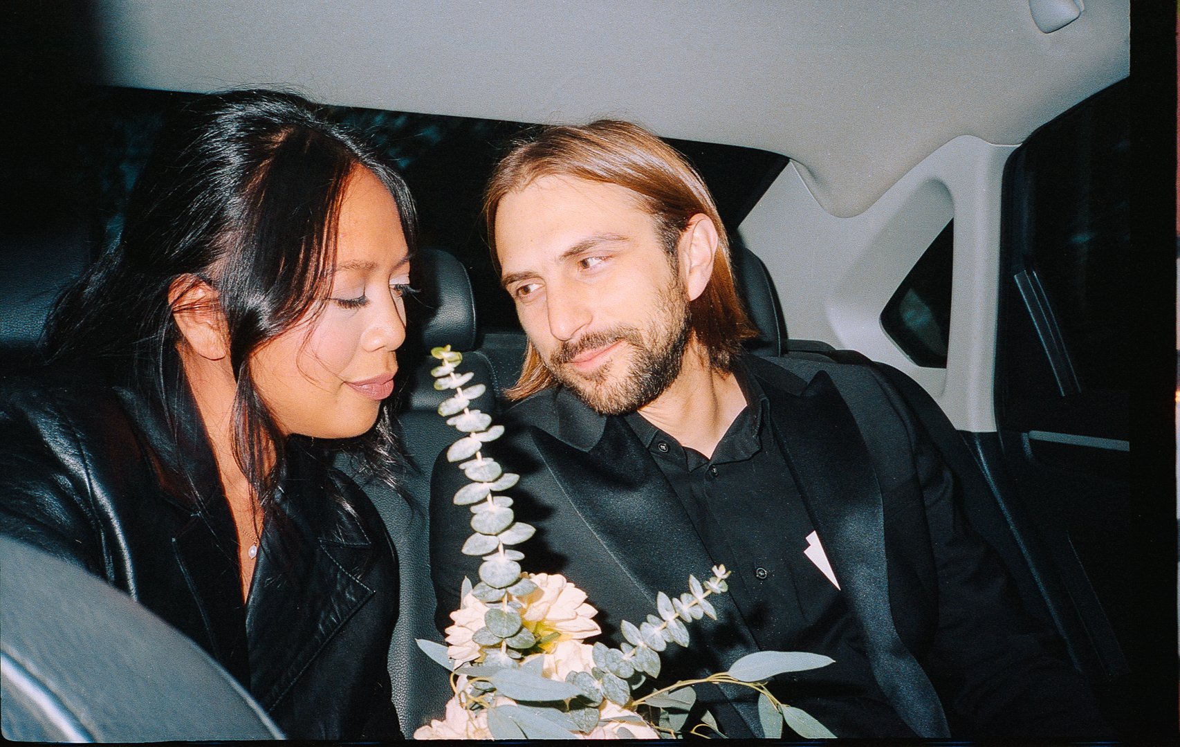 bride and groom in back of taxi flash photo after City Hall Elopement in downtown chicago on film. Grace Coudal is a Chicago lesbian photographer specializing in portraits, candid, editorial, documentary, events, + weddings. Analog film wedding photo