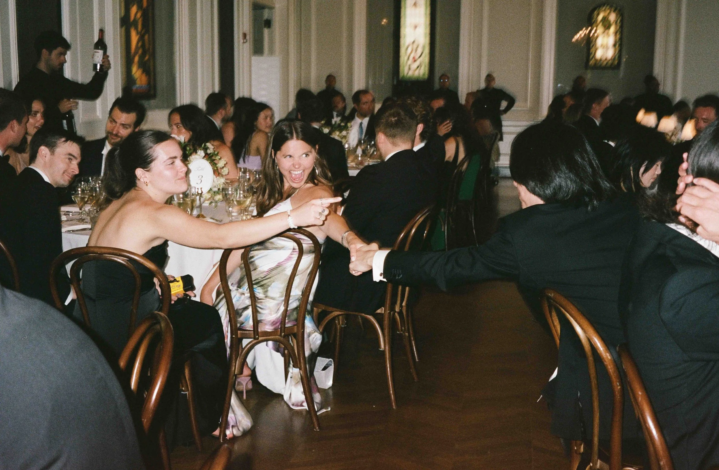 Bride and groom get married at the Chicago History Museum, with creative, lively wedding focused on community, family, laughter. Documentary and candid photos on analog nostalgic film. Weddings by Grace is a Chicago lesbian queer luxury wedding photo