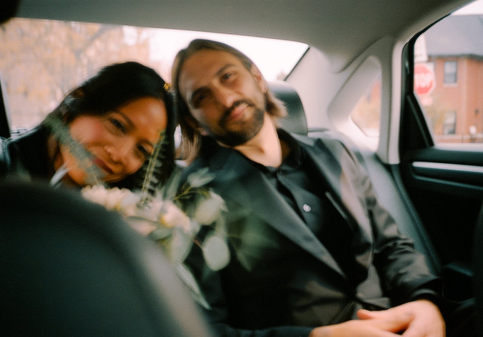 bride and groom in back of taxi flash photo after City Hall Elopement in downtown chicago on film. Grace Coudal is a Chicago lesbian photographer specializing in portraits, candid, editorial, documentary, events, + weddings. Analog film wedding phot