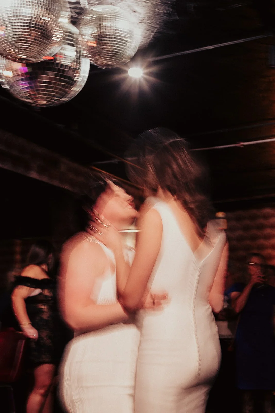 Fun flash photos of lesbian wedding at Dorothy bar. Documentary and candid photos on flash film. Weddings by Grace is a Chicago lesbian queer luxury wedding photographer specializing in portraits, candid, editorial, documentary, + artistic images wit