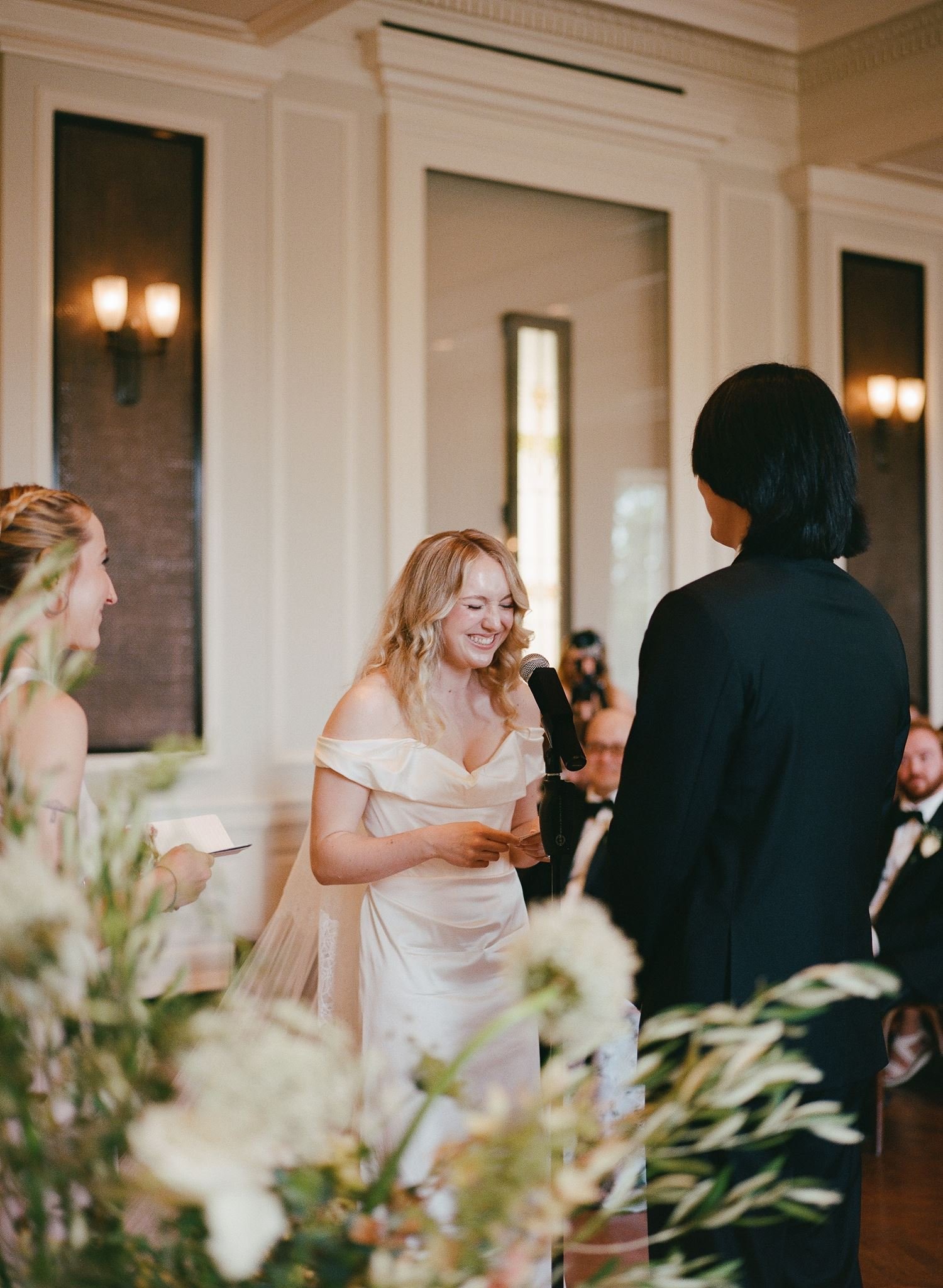 Bride and groom get married at the Chicago History Museum, with creative, lively wedding focused on community, family, laughter. Documentary and candid photos on analog nostalgic film. Weddings by Grace is a Chicago lesbian queer luxury wedding photo