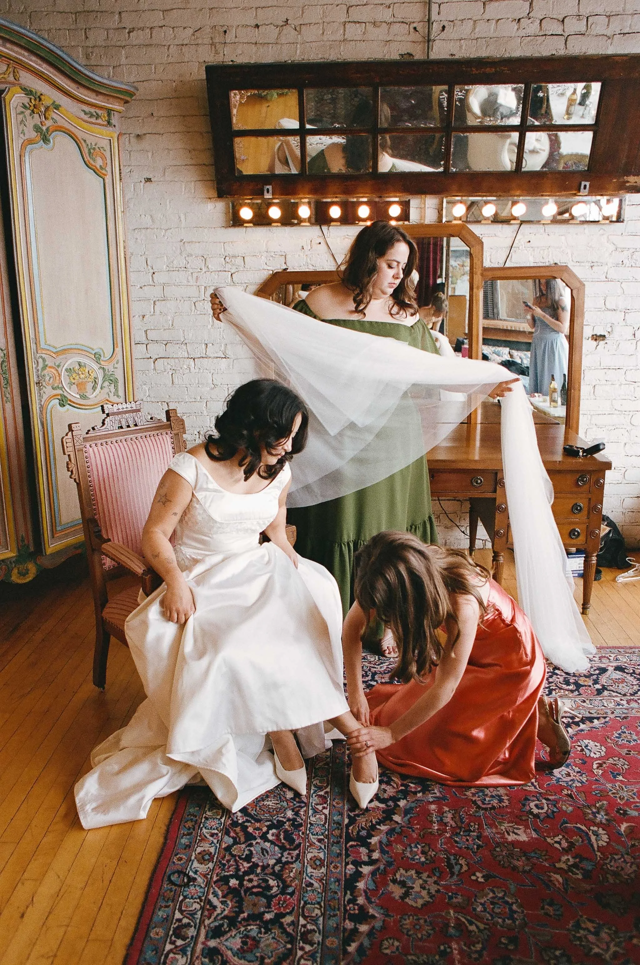 Bride and groom get married in Chicago at Salvage One, with creative, lively wedding focused on community, family, laughter. Documentary and candid photos on analog nostalgic film. Weddings by Grace is a Chicago lesbian queer luxury wedding photograp