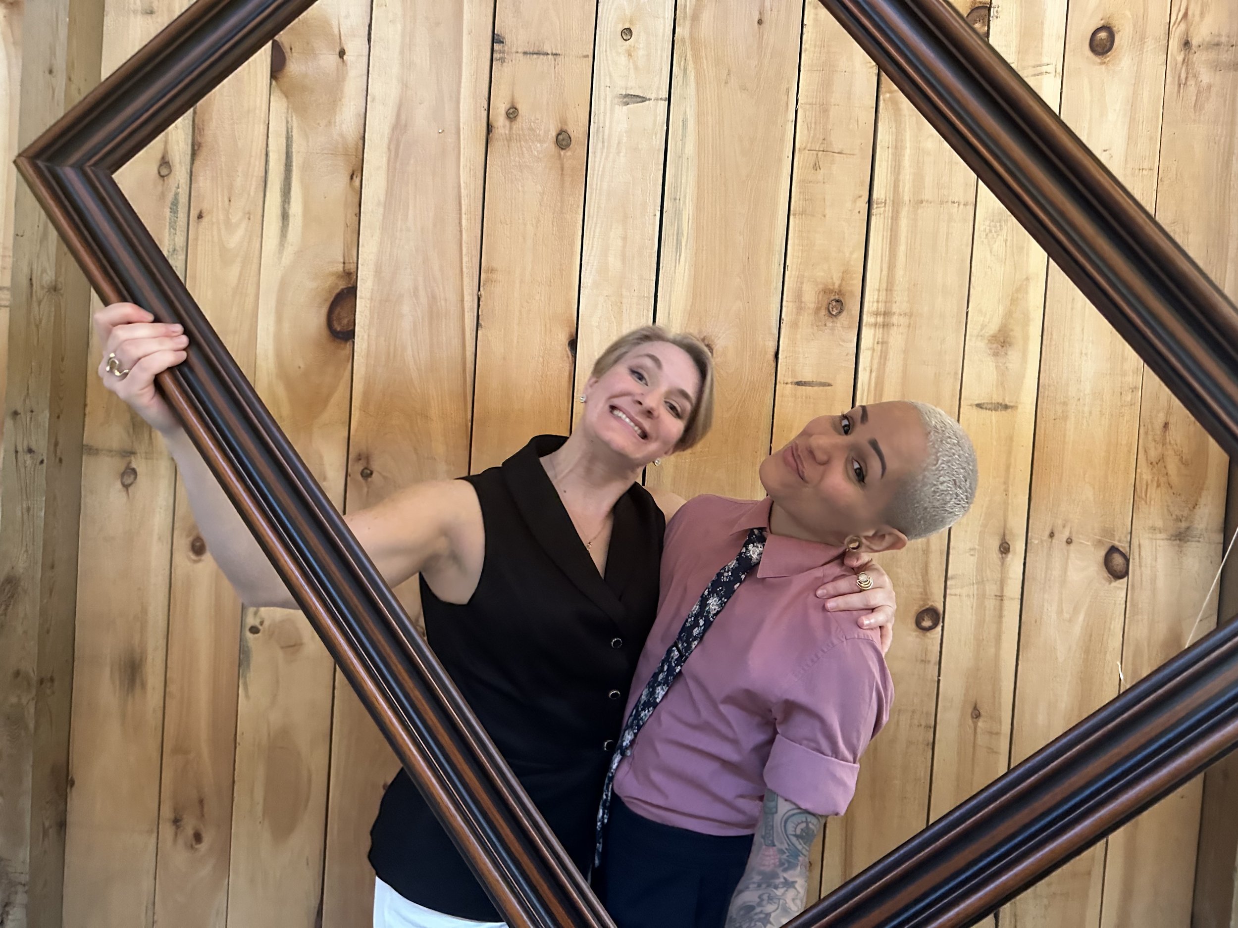 Me and my favourite person being silly at a family member's wedding (E and his friend posing while holding up a photo frame)