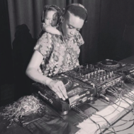A woman and her daughter operating DJ equipment at a party or event.
