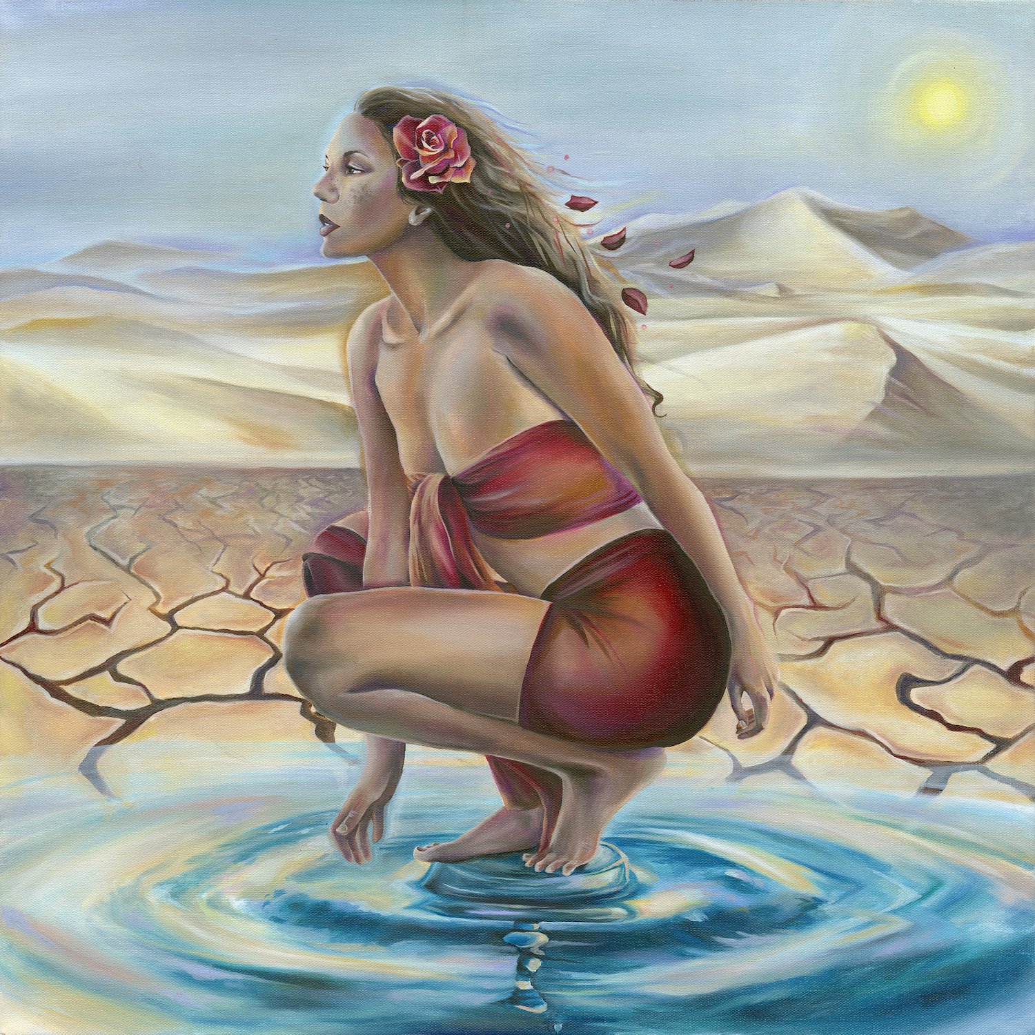 A woman with long hair and a pink flower in her hair, dressed in a red cloth, crouching in a body of water with cracked dry land in the background and mountains beyond. The sky is partly cloudy with the sun visible.