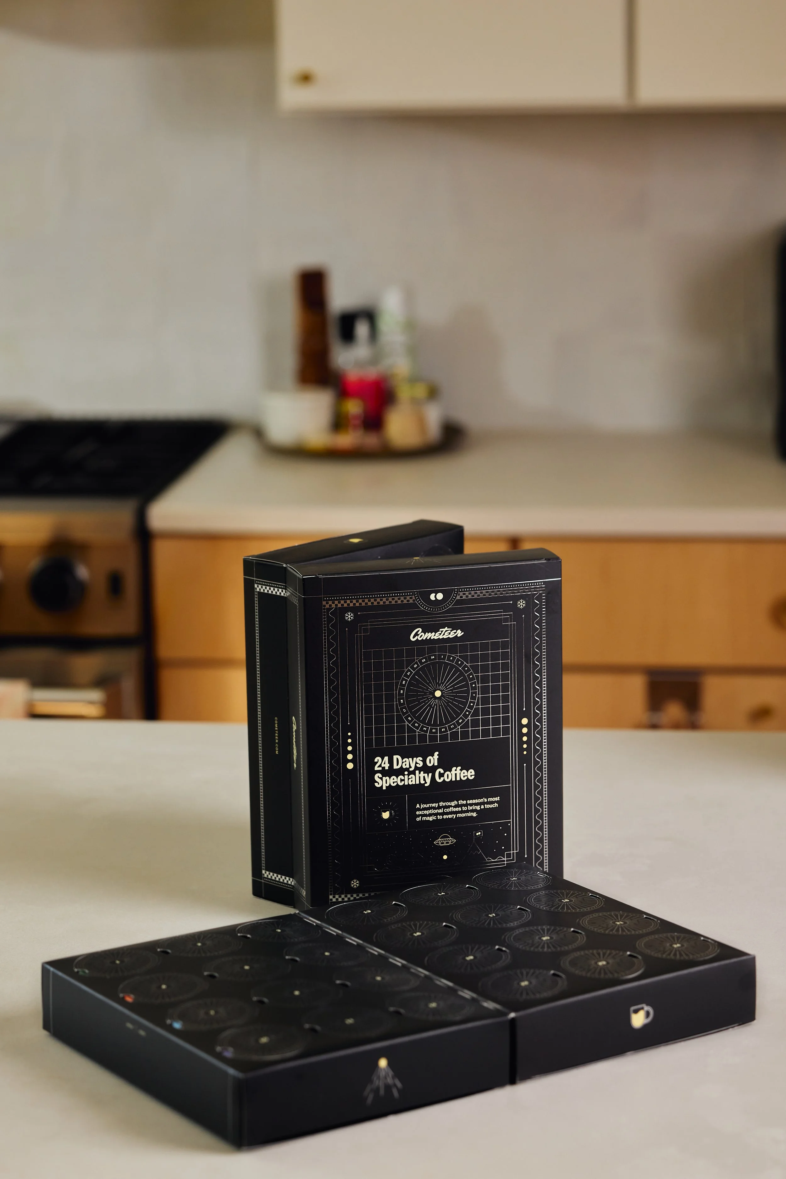 Boxed coffee sampler labeled '24 Days of Specialty Coffee' on a kitchen countertop for Commercial product photography Campaign 