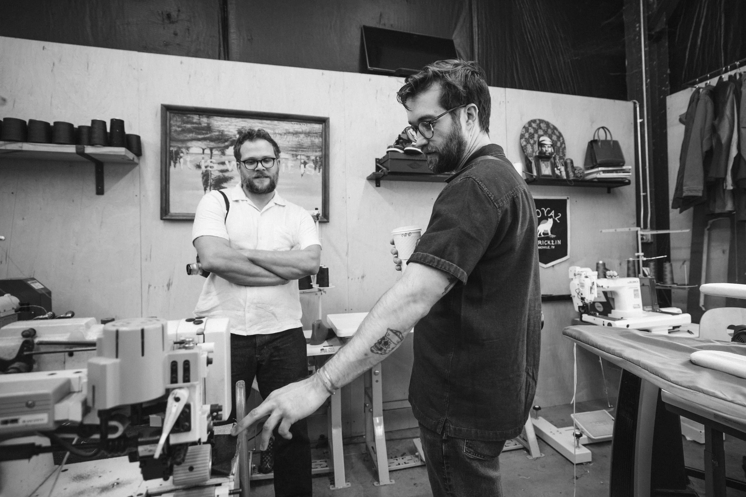Two men on a filmset that is located in a workshop for a brand documentary on local craft businesses.