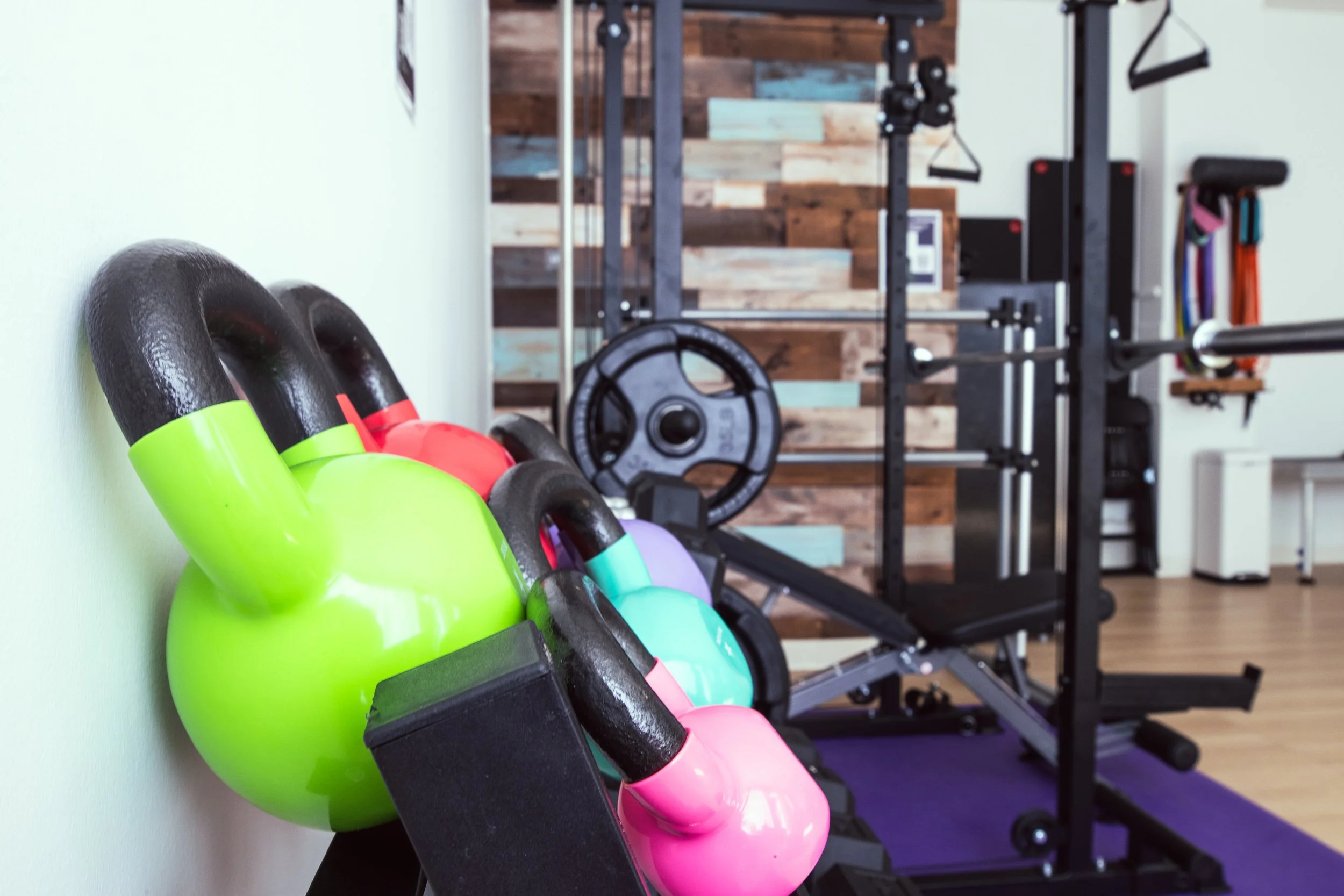 Zoomed in image of colorful kettlebells and strength training equipment at ESTIA House of Movement.