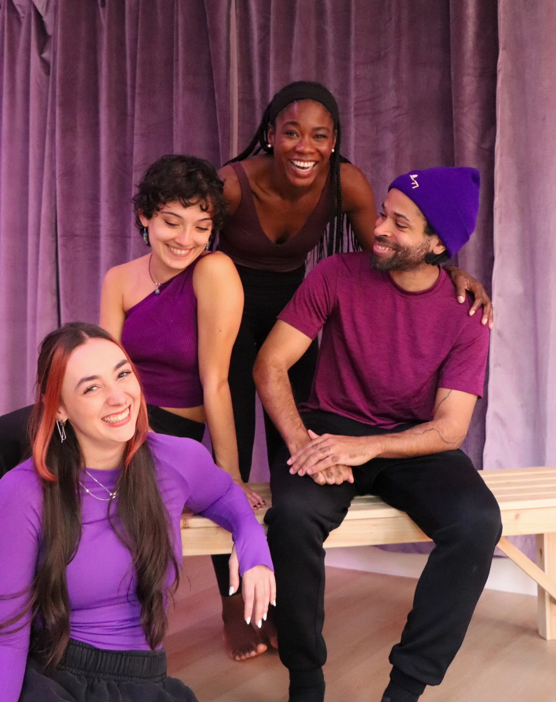 Four ESTIA House of Movement instructors smiling together in the studio.