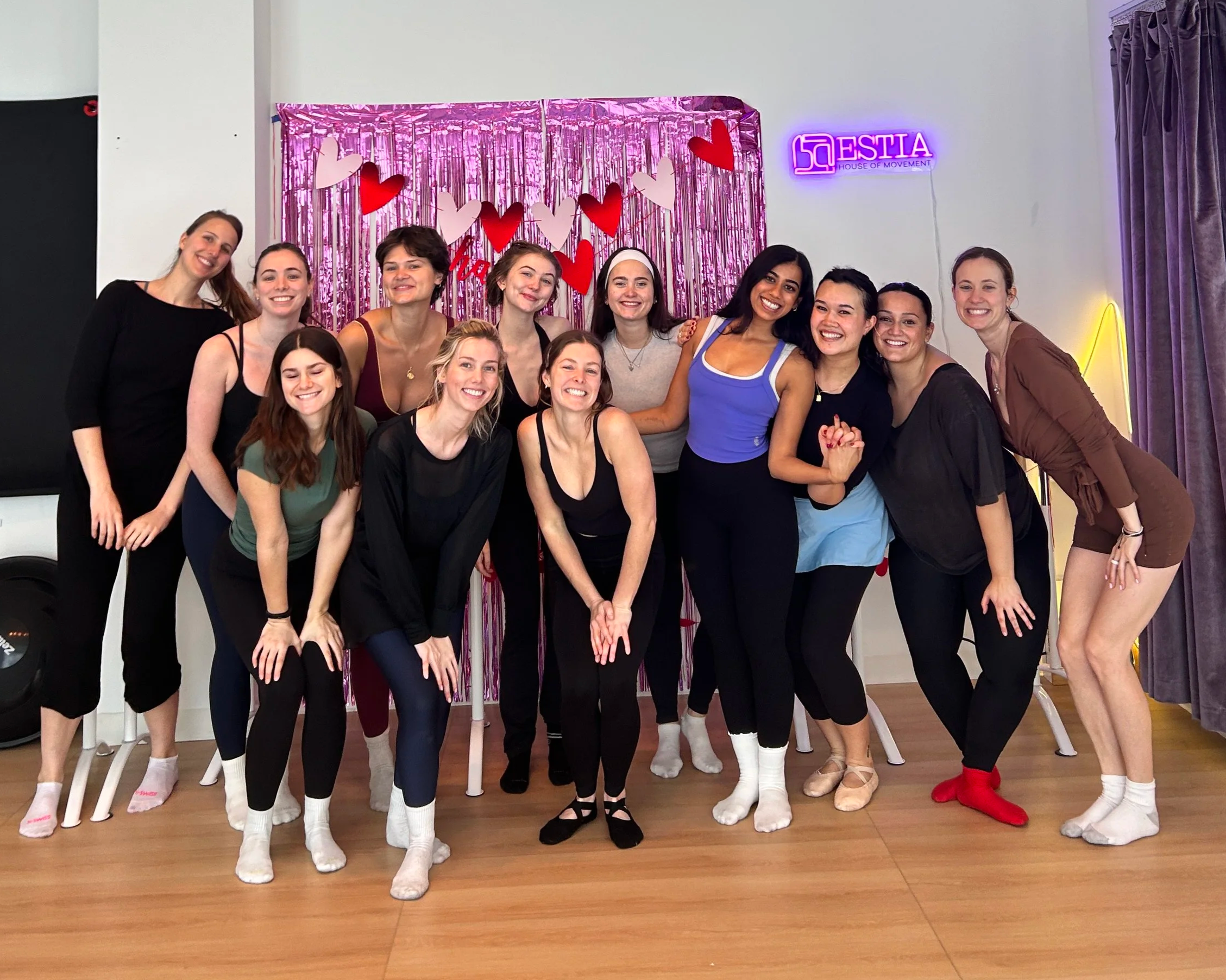 Group of adults posing together after a fitness class at ESTIA House of Movement.