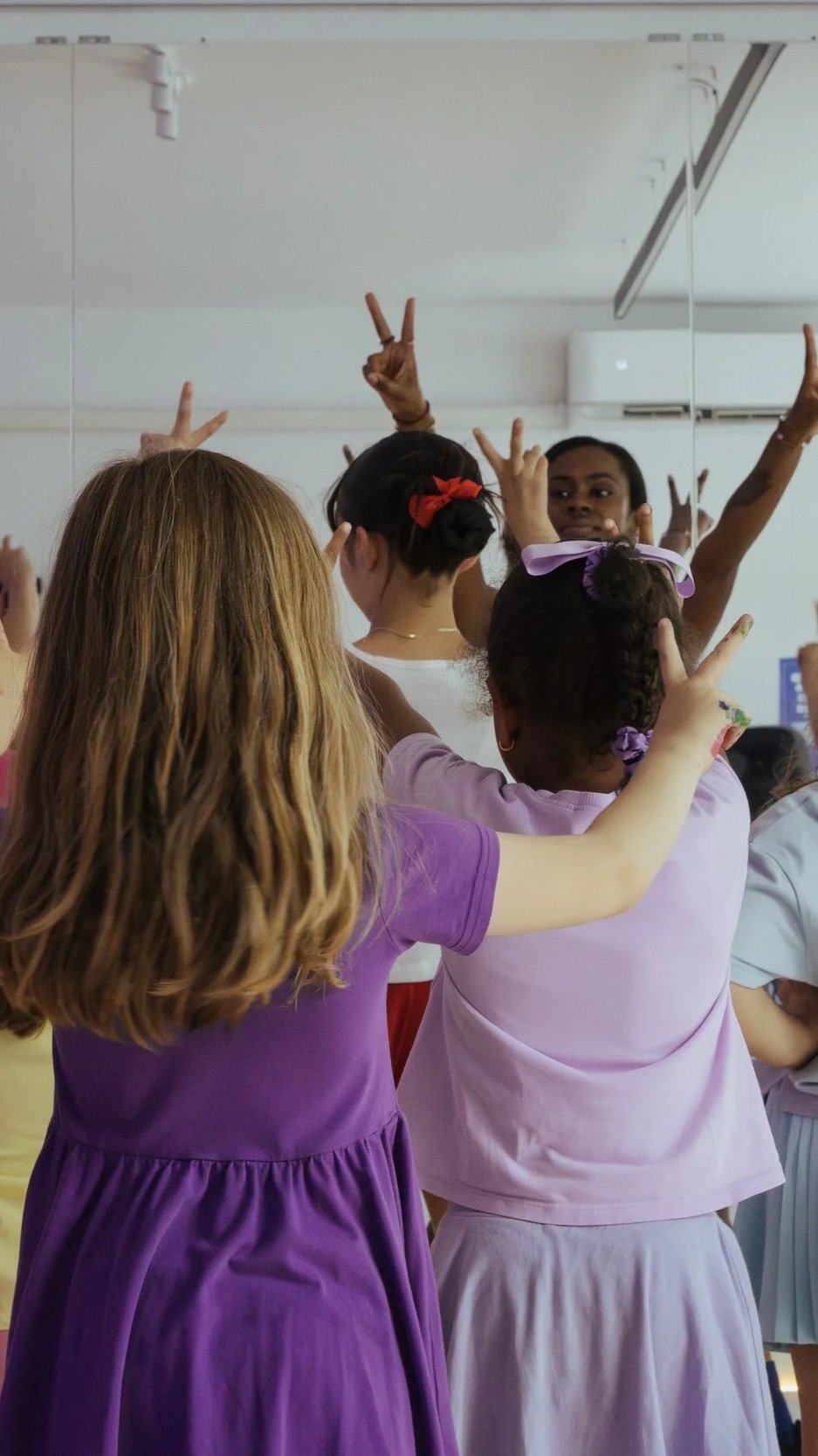 Dance instructor leading children through a movement activity during a kids dance class at ESTIA House of Movement.