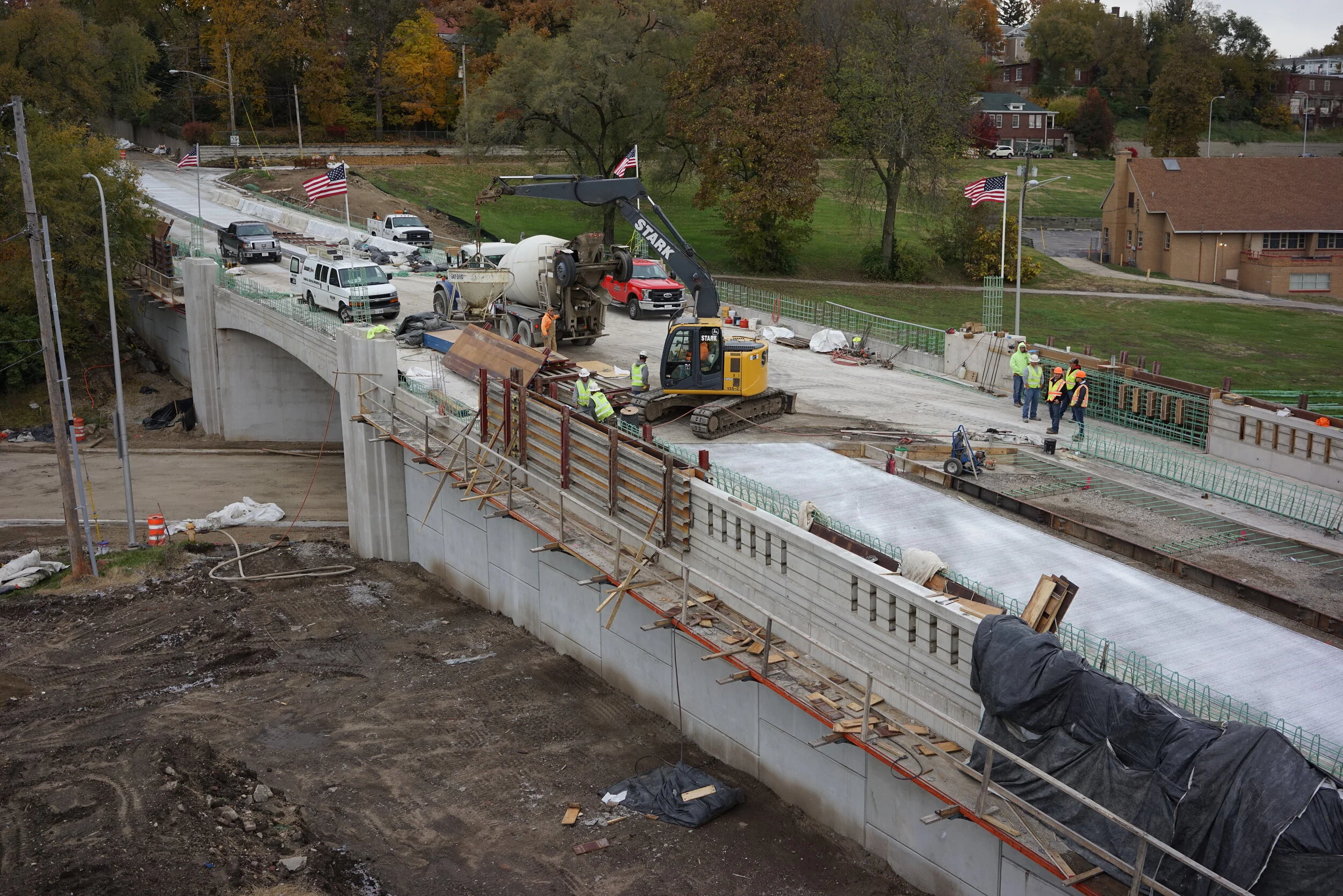 Construction workers and machinery working on a bridge project. 