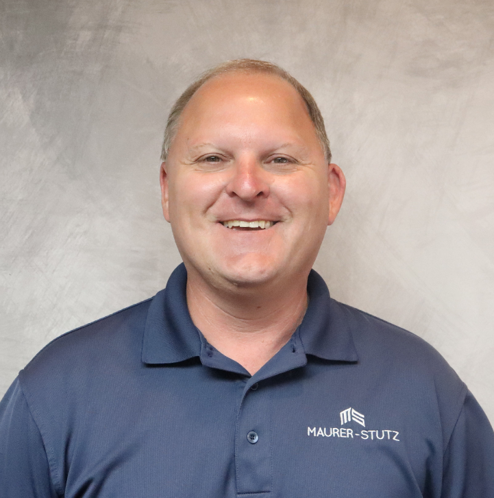A smiling man in a navy blue polo shirt with the company logo 'MAURER-STUTZ' stands in front of a plain background.