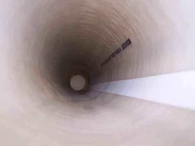 Inside a cylindrical pipe or tunnel.